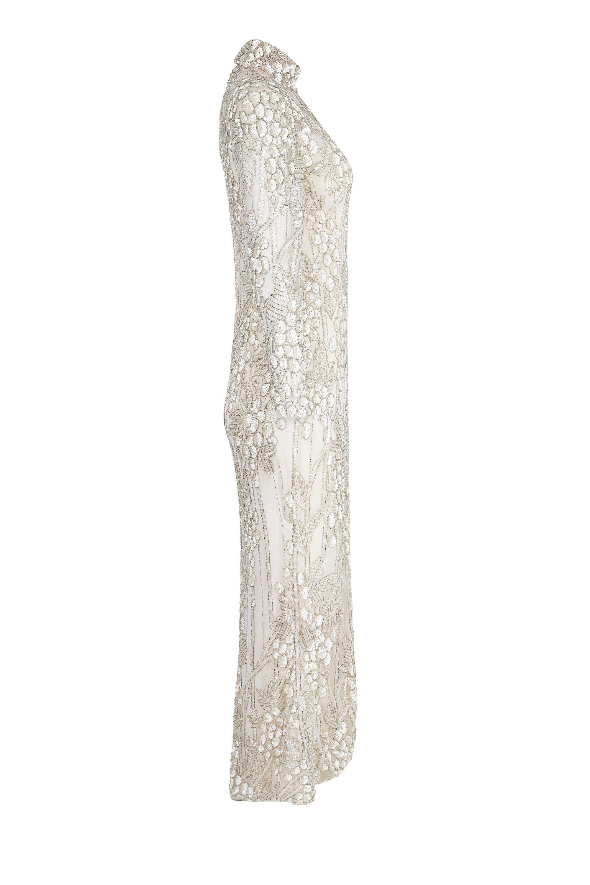 This sensational early 1990s ivory silk beaded couture bridal gown is by American designer Bill Mackie who was widely extolled for his on and off screen creations for famous divas such as Diana Ross, Cher and Carol Burnett. His look was synonymous