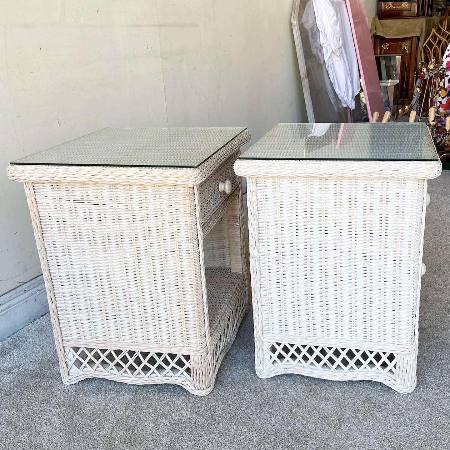 Incredible pair of vintage bohemian nighstands with glass tops. Each feature a washed white wicker throughout.