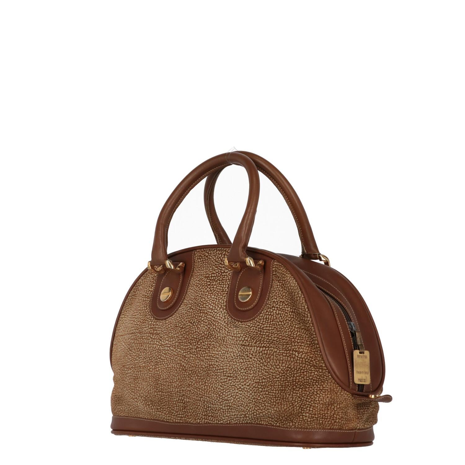 A.N.G.E.L.O. Vintage - ITALY
Borbonese beige suede with jet op print half-moon bag and edges finished in brown leather. Two leather handles with golden metallic details, double-slider zip closure.

The product shows slight signs of wear on the