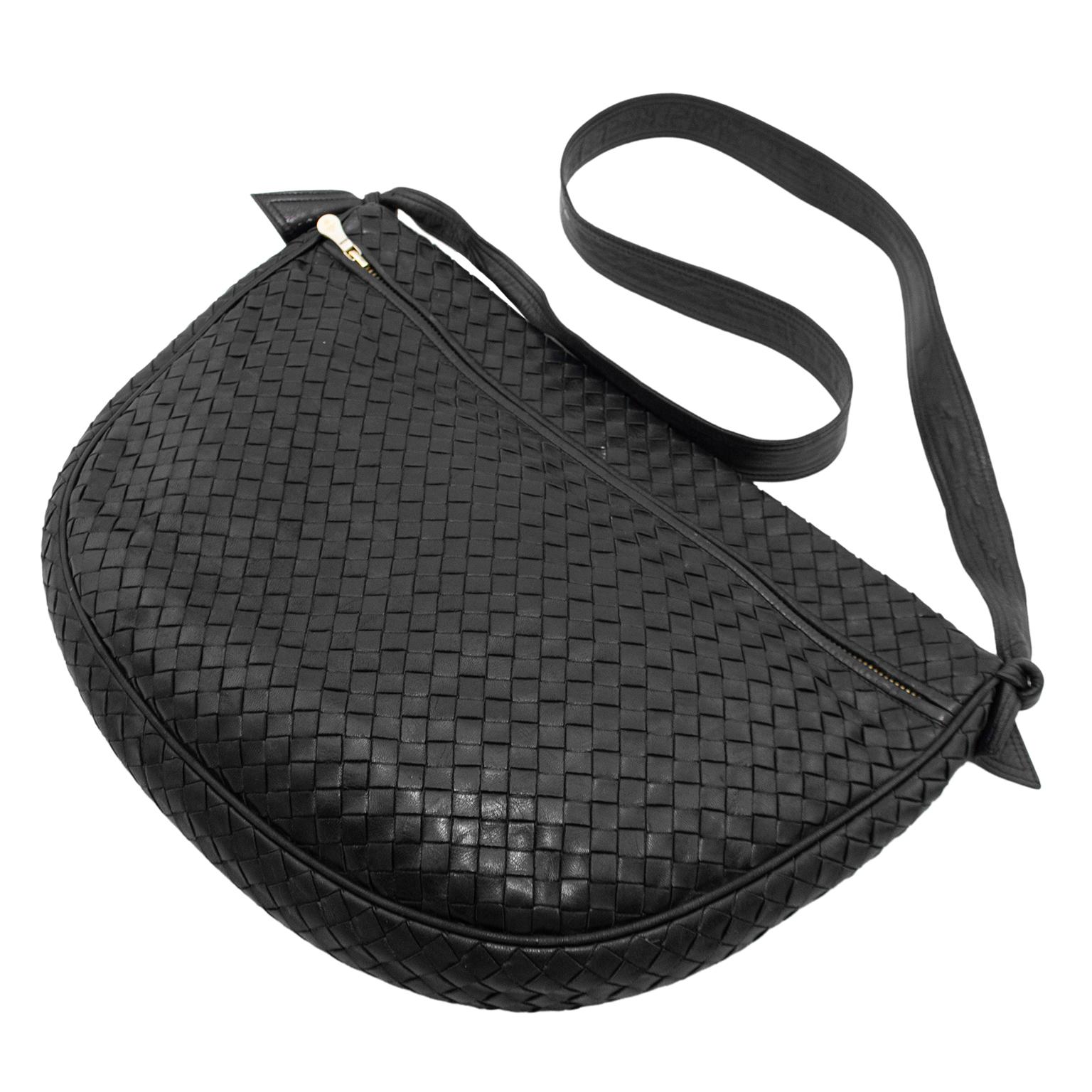 A 1990s Bottega Veneta classic that is the inspiration for the newest Bottega Veneta collections. Black intrecciato leather unstructured hobo style bag. Two top zippers that open into large compartments, one lined in beige suede and the other in