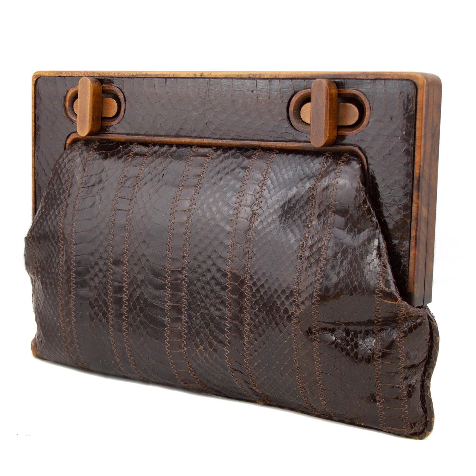 Super chic 1990s Bottega Veneta large rectangular clutch. Brown stamped reptile with thick wood frame. Two large twist locks on front of wood frame. Clean brown interior with single zippered slit pocket and gold brand plaque. Very good vintage