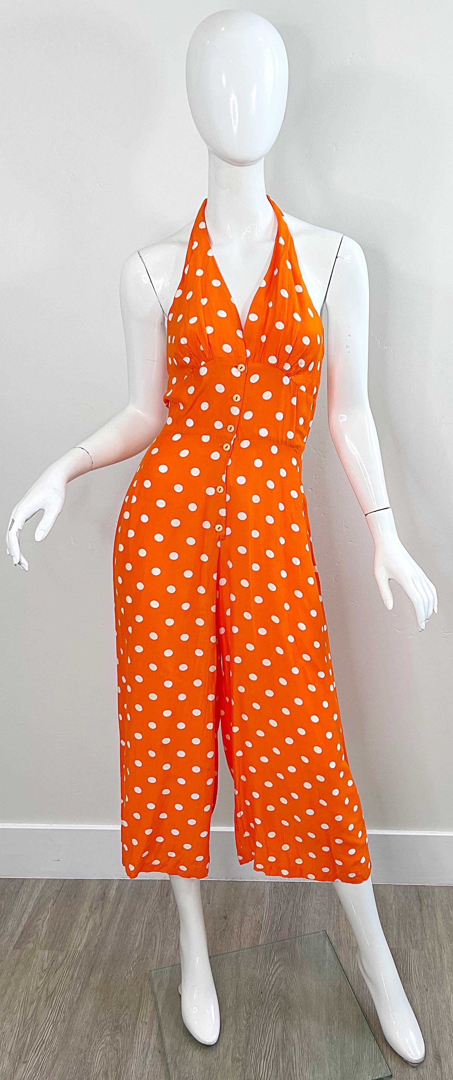 Beautiful early 90s bright orange and white polka dot halter culottes jumpsuit ! Soft lightweight rayon fabric. Buttons up the front, and ties at top center neck. The perfect alternative to a dress.
In great condition 
Made in USA
Approximately Size
