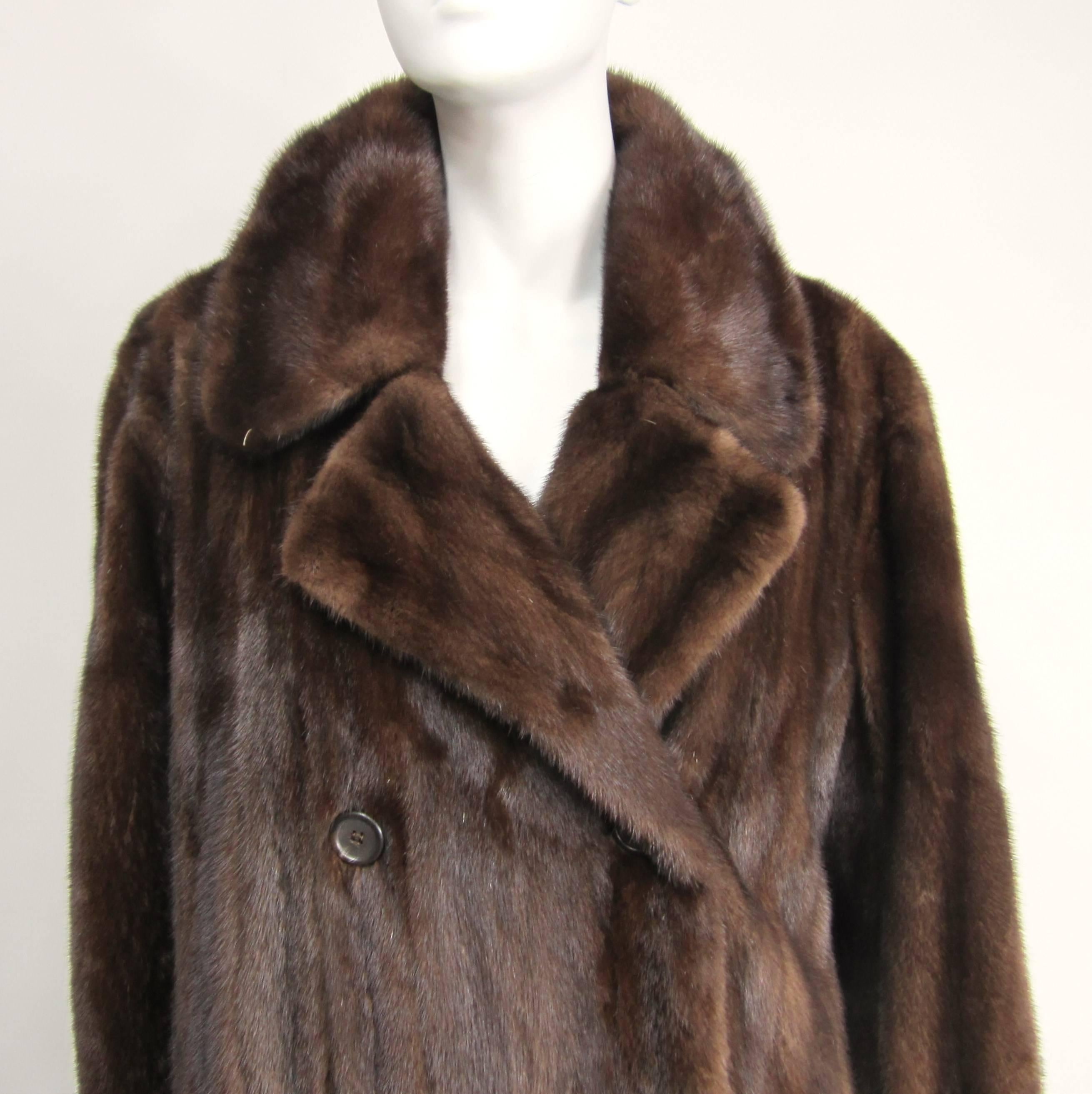 Stunning Double Breasted Mink Coat. Faux Belt on the back, with kick pleat. Chestnut Brown in color, soft and supple. Lining Brown, monogrammed inside. The lining has a couple of spots, see photos. French Hem. Lined slit pockets. Will fit a 10-12