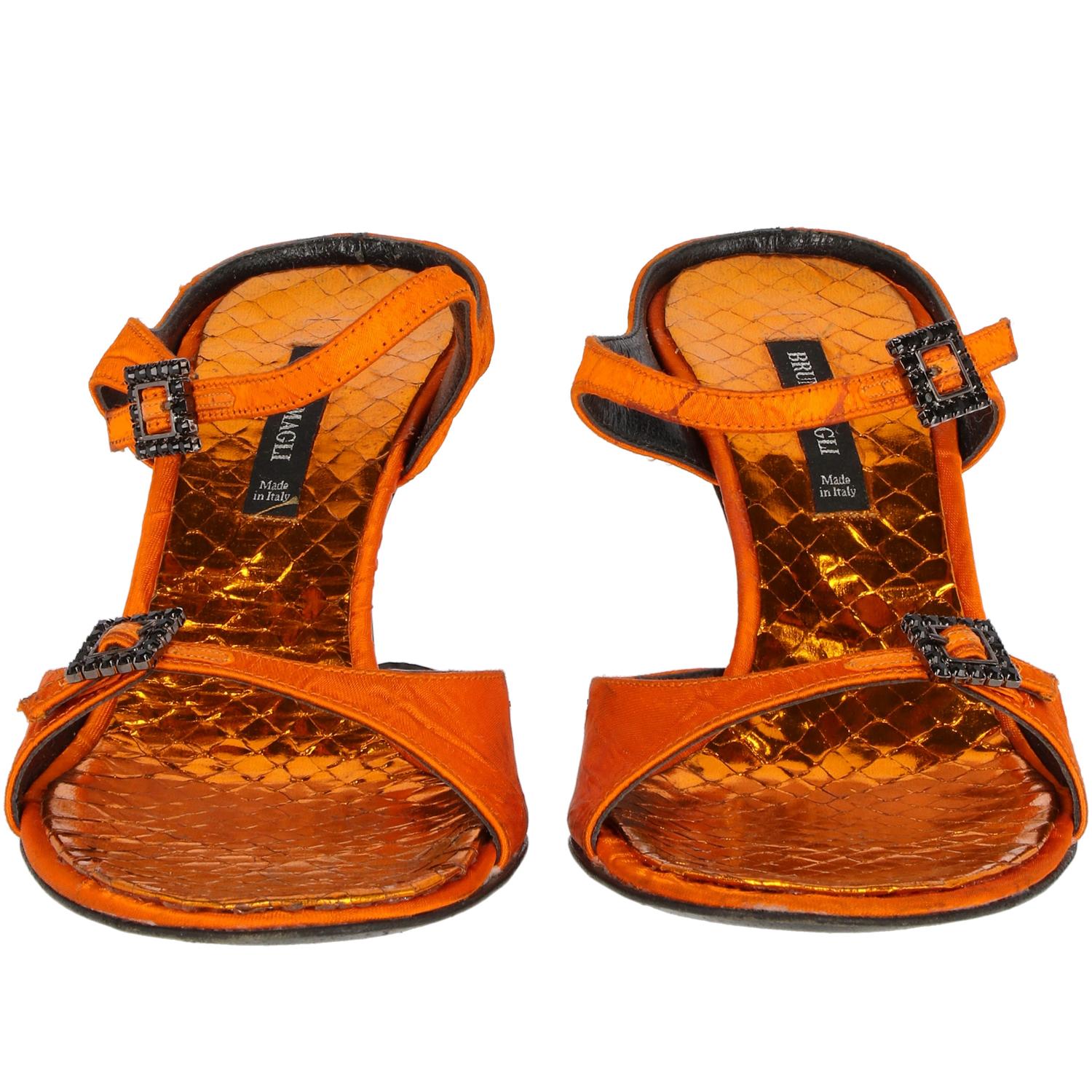 90s Bruno Magli orange sandals. Two foot straps and black strass embellished buckles. Metallic orange python insole and black heel. 

The item is vintage and shows some signs of use, as shown in the pictures.

Years: 90s

Size: 37 EU

Heels height: