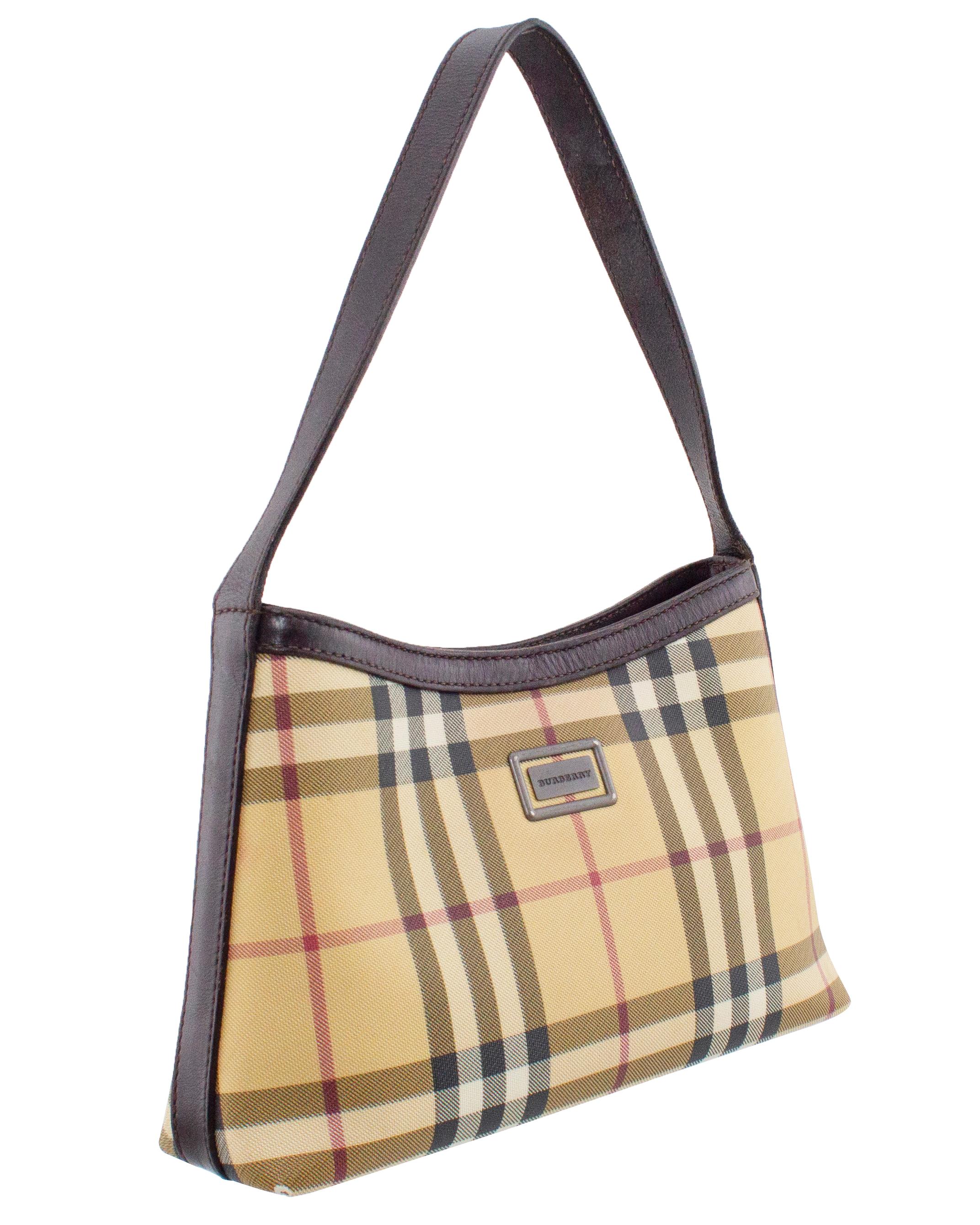 Mid to late 1990s Burberry coated canvas mini shoulder bag in the classic Nova check. Trimmed in dark brown leather, the bag has a circular snap button closure and one interior zipper pocket. Lined in brown Burberry fabric with metal logo plaque on