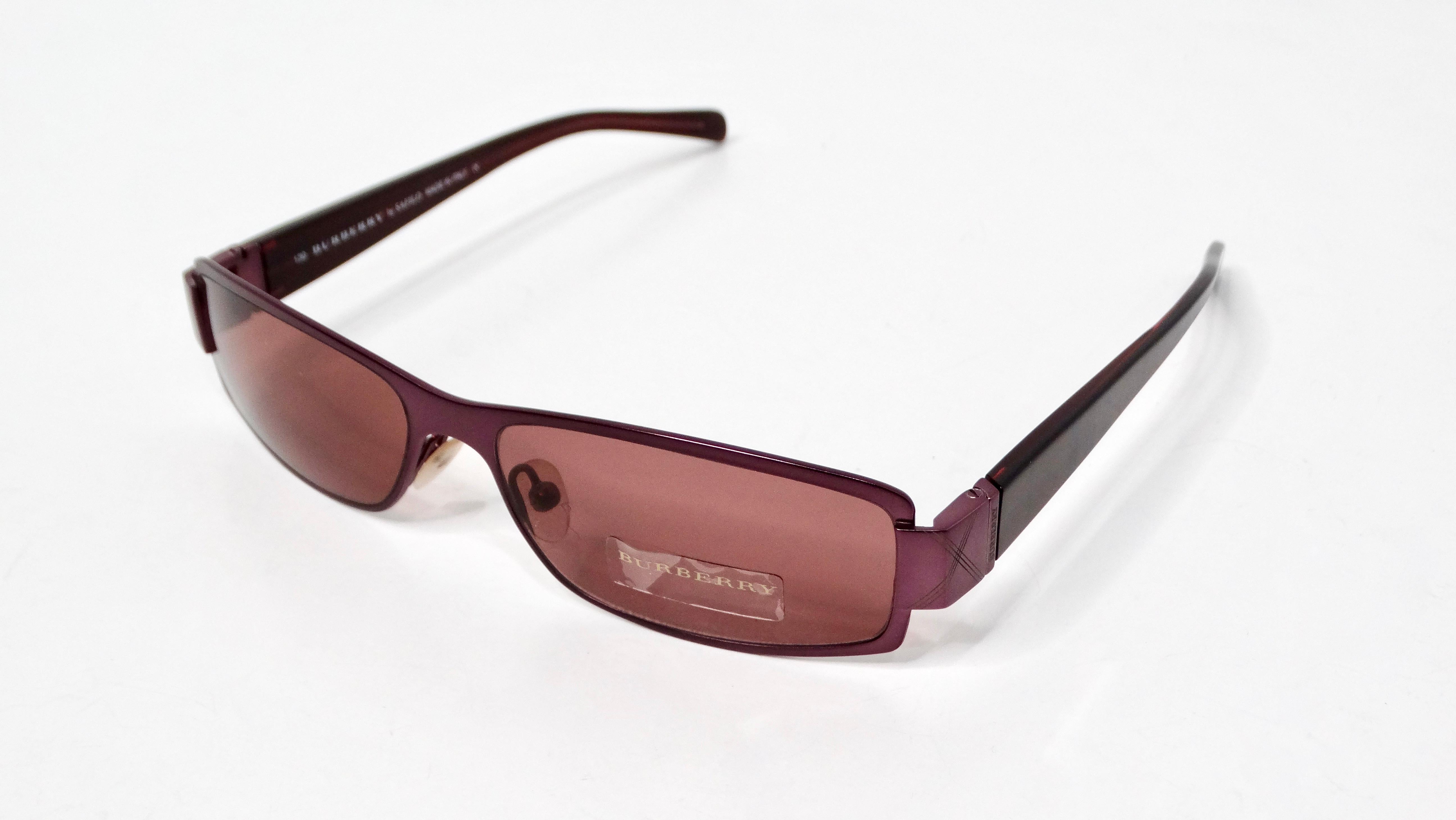 Gli occhiali da sole Burberry Purple Check Rectangular Frame Tinted degli anni '90 incarnano le audaci dichiarazioni di moda dell'epoca. Con un sorprendente motivo a quadri viola, questi occhiali da sole combinano un'estetica vintage con un tocco