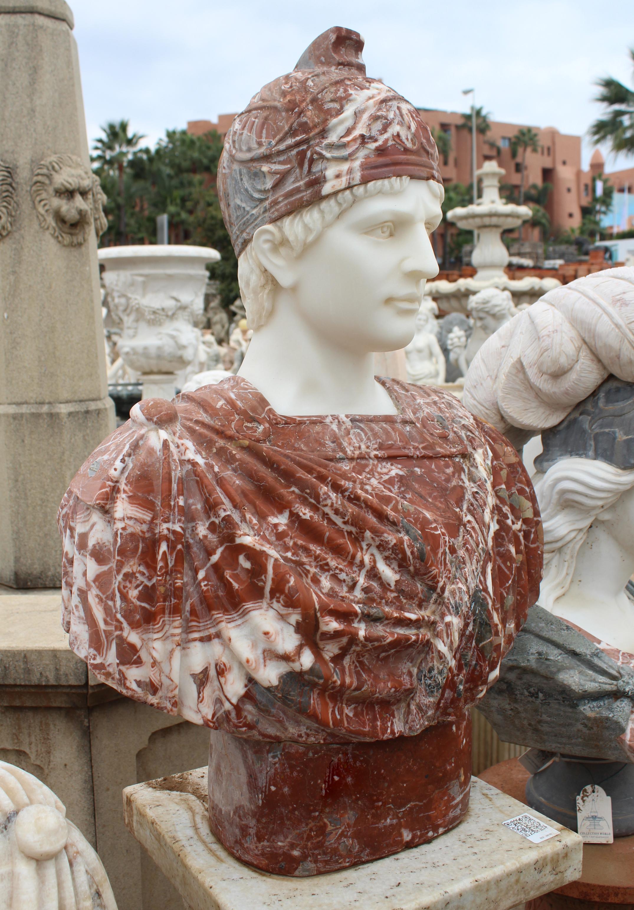 1990s bust of a Roman, hand carved by craftsmen using Carrara white marble for the head and Alicante red for the toga, where the white veins give movement and realism to the cloth.
 