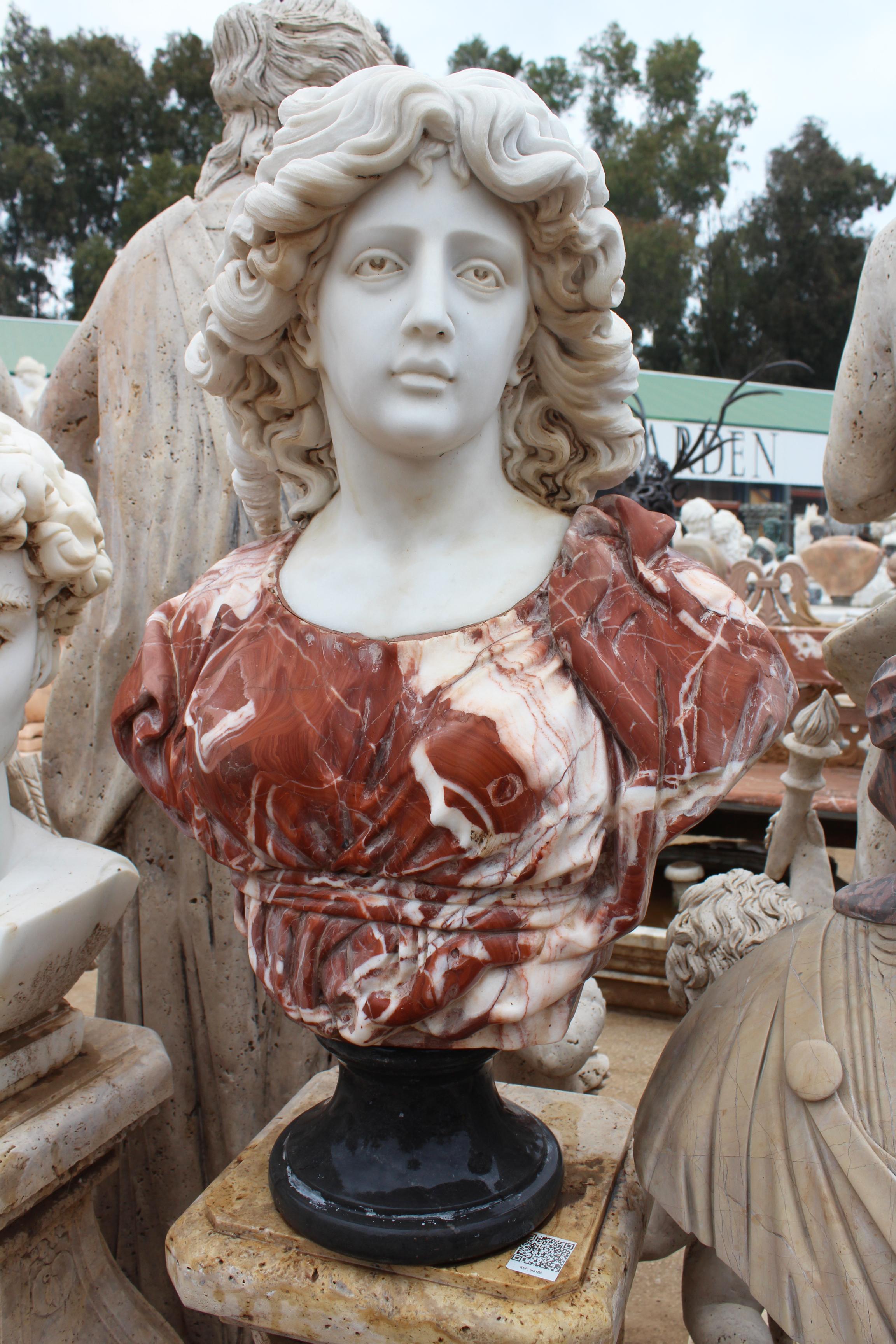 1990s bust of a woman, hand carved by craftsmen using Carrara white marble for the head and Alicante red for the cloth, where the white veins give movement and realism to the cloth. Simple round base in Belgian black marble.
 