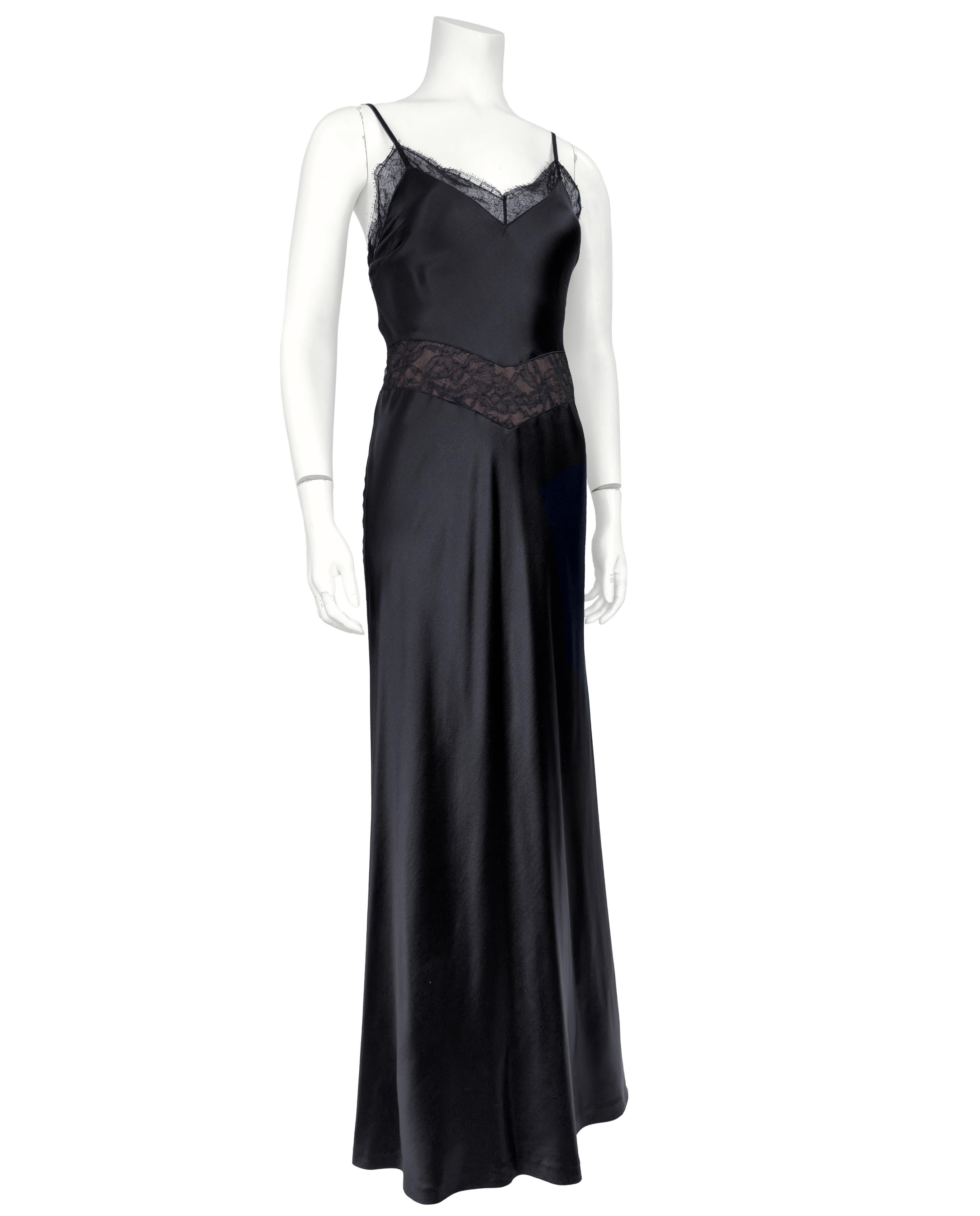 Minimal yet romantic 1990s Calvin Klein Collection black lingerie style evening slip gown. Spaghetti straps with sheer black lace trim at the neckline and a nude lined lace shallow v shaped inset at the waist. The dress glides effortlessly over the