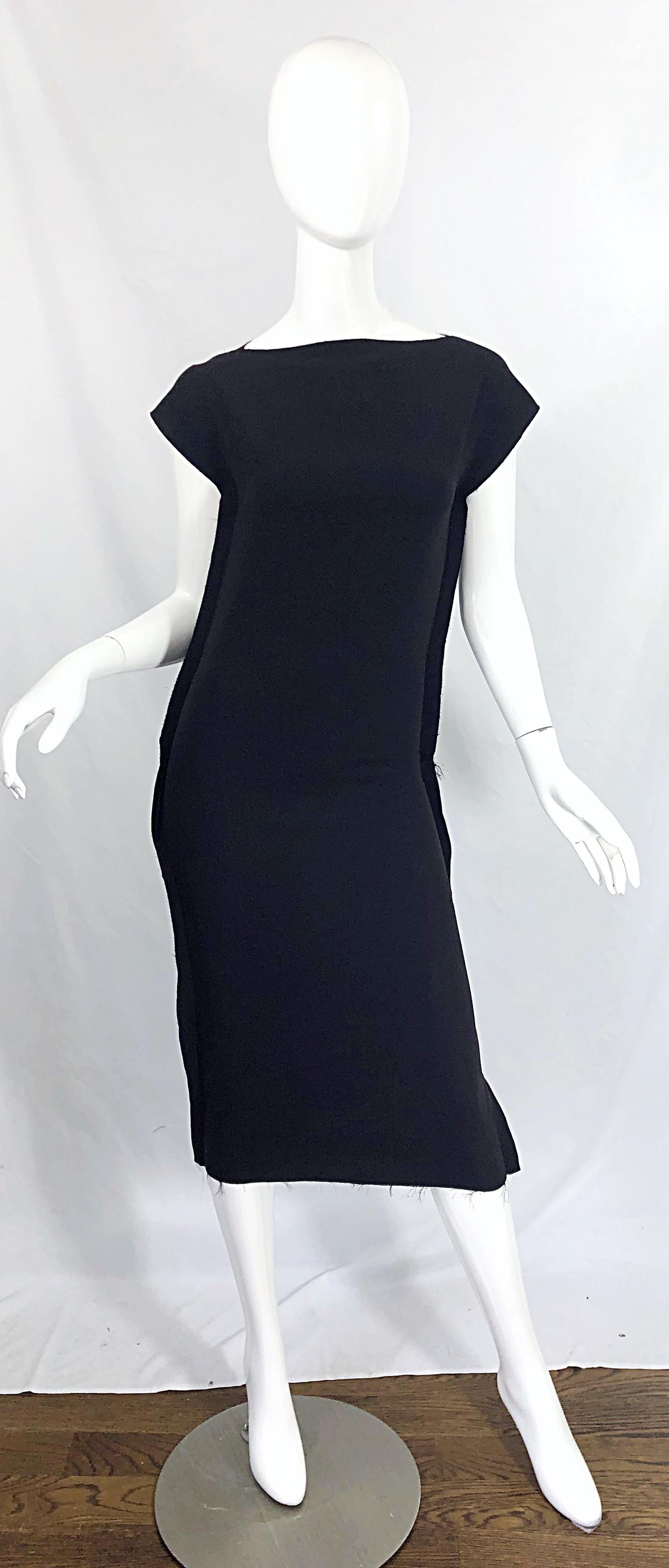 Such an amazing take on the little black dress ! CALVIN KLEIN COLLECTION black jersey 'Inside Out' short sleeve midi dress ! Features unfinished seams that look like they are inside out. Hidden zipper up the back with hook-and-eye closure. The