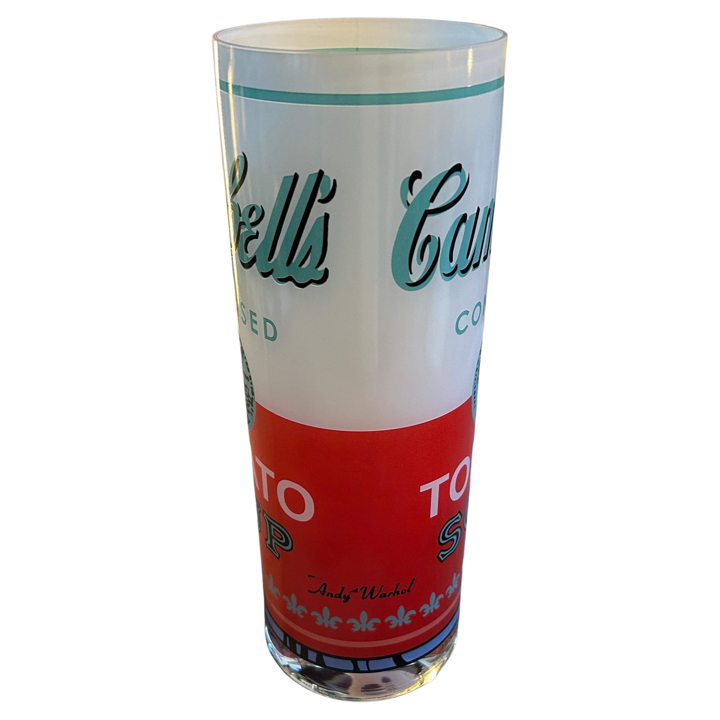 The Rosenthal Campbell soup glass vase designed by Andy Warhol is a piece of pop art that captures the iconic imagery of the Campbell's Soup can in a functional and stylish manner. The vase of high-quality glass, with a smooth and glossy surface