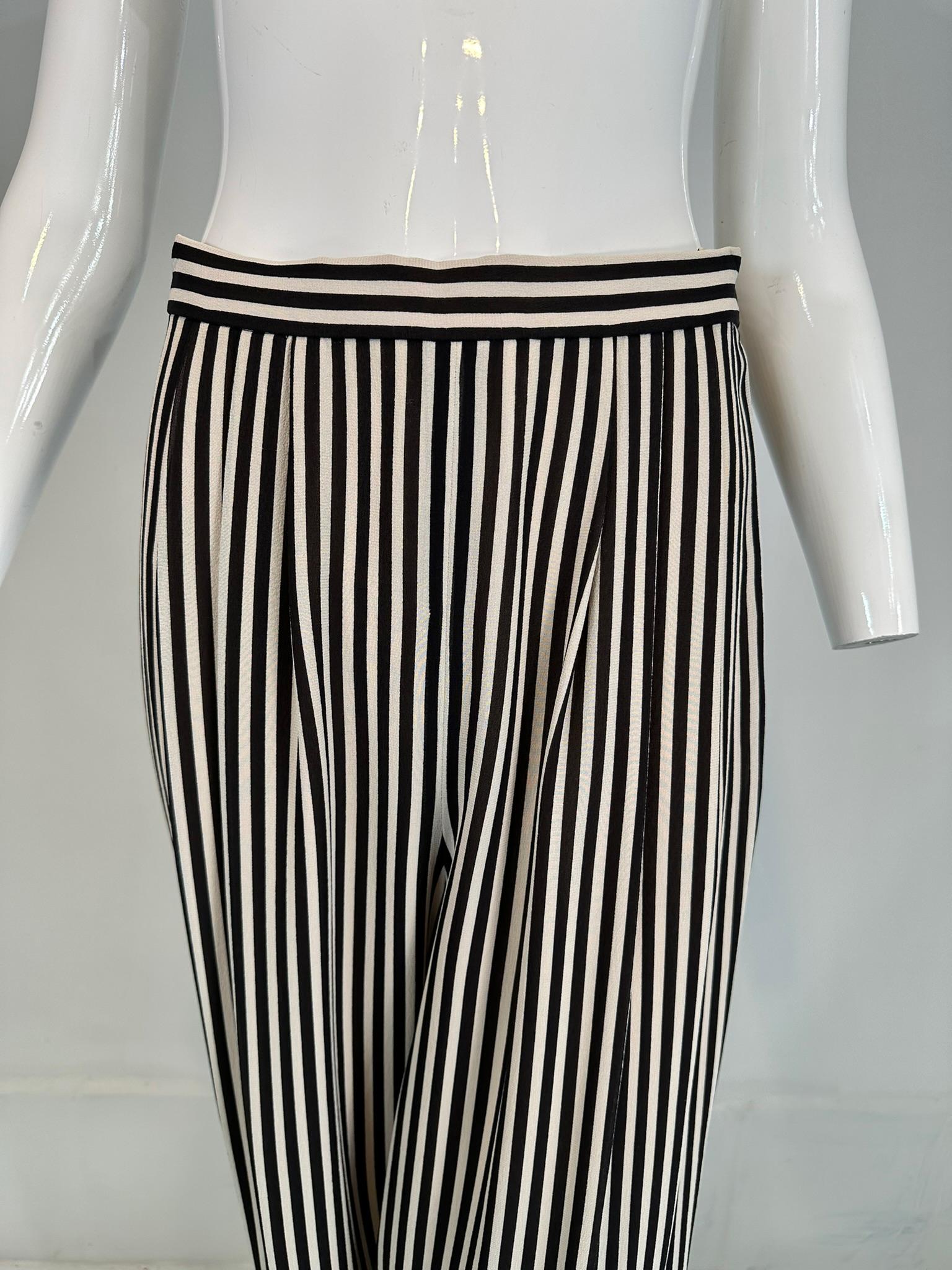 1990s Carlislie black & white silk stripe pleat front wide leg trouser. Wide flowey legs, hip front pleats at waist band. Narrow band waist, with side button closure & zipper below. Fully lined in lightweight nude silk crepe. These will be the