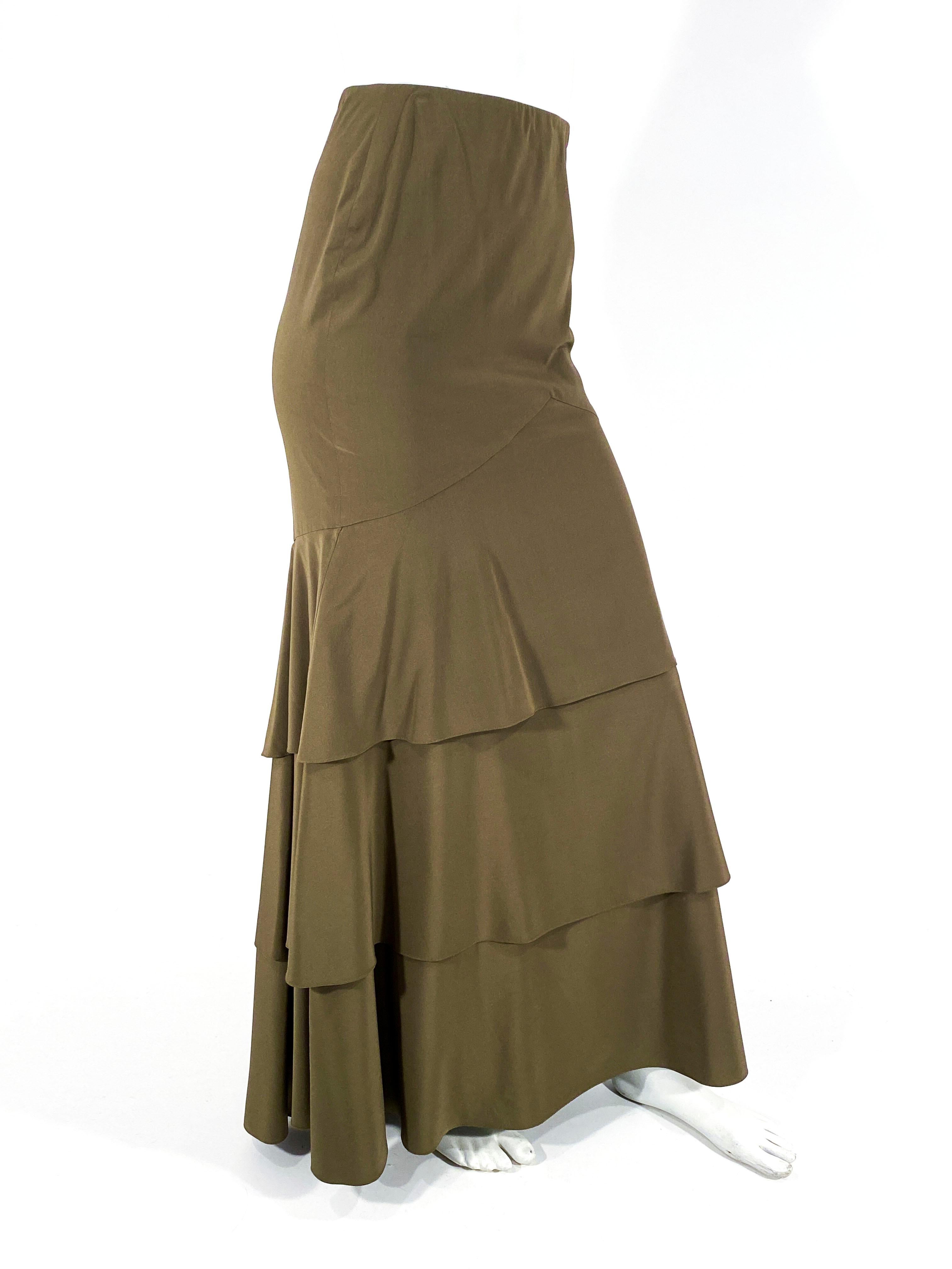 1990s Carolina Herrera Olive/brown silk mermaid skirt with multi-tiers down the hem of the skirt. The back has an elongated fishtail from the hip down. The hip is fitted for a flattering silhouette. The back has a hidden zipper closure on the clean
