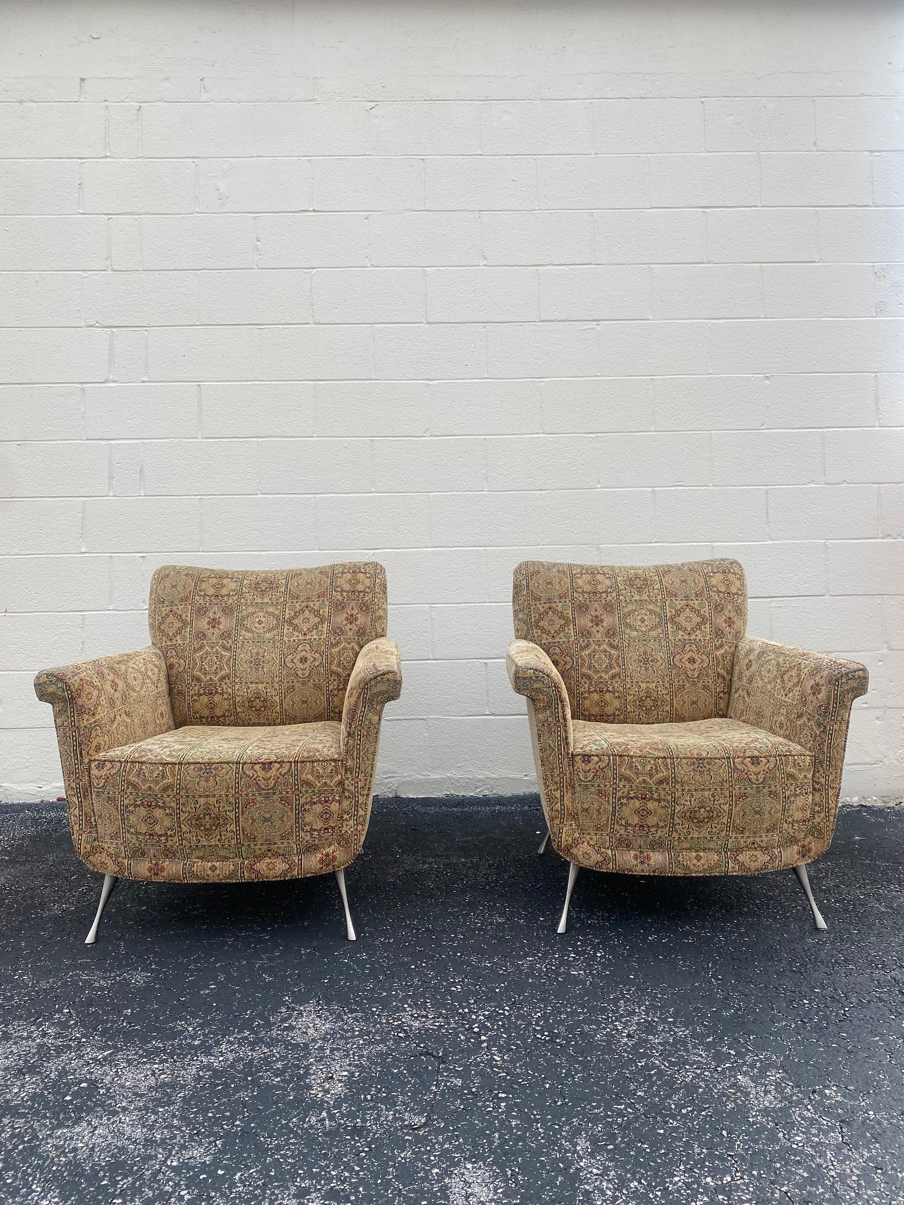 These timeless textile chairs are packed with personality! Outstanding design is exhibited throughout the monumental form. Post modern Chairs are beyond stunning. Sits on a metal pin legs. The sculptural shape also feature a comfortable sculpted