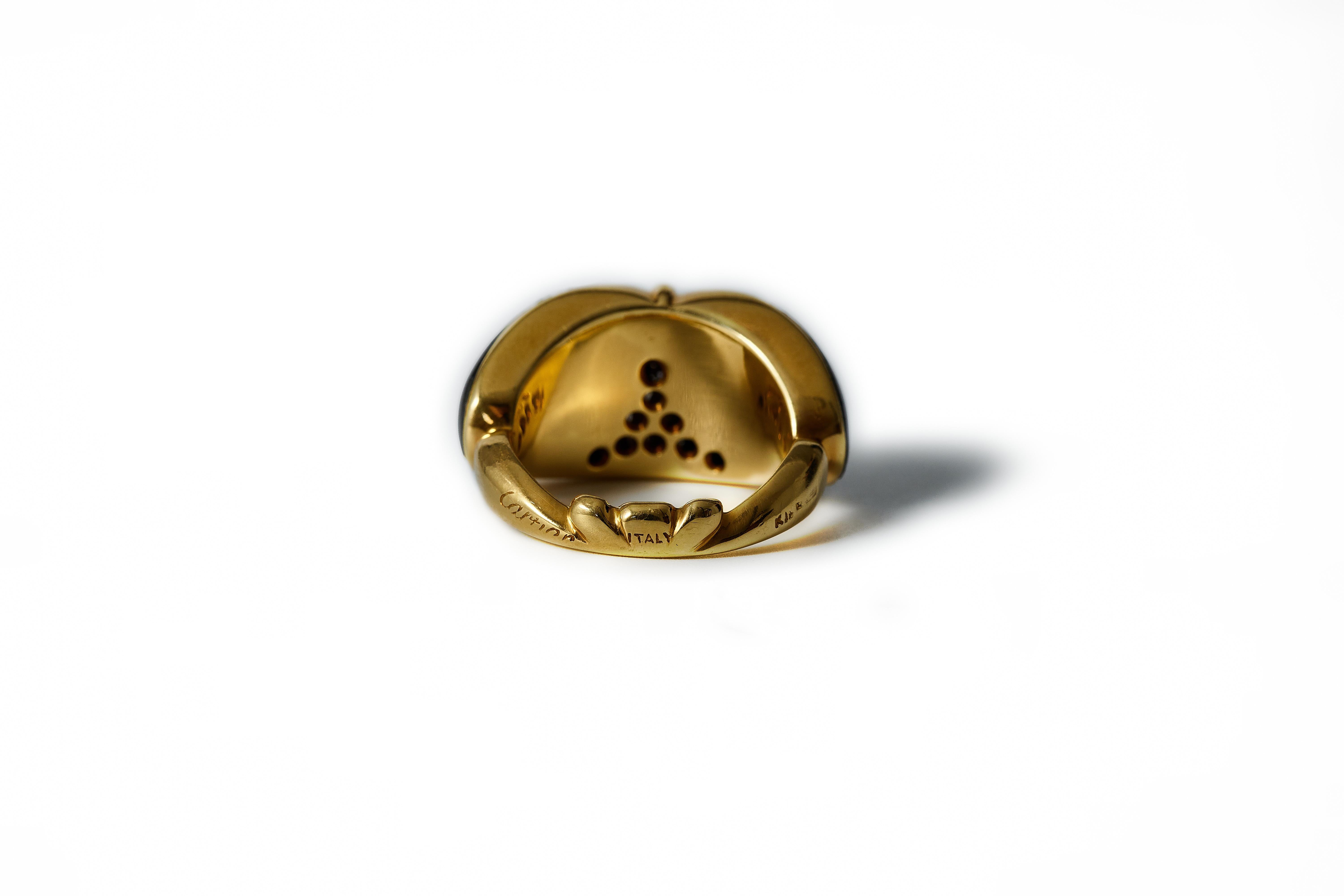 1990s Cartier Diamond Onyx Ring. 
Front onyx inlay with 13 pavé set round brilliant cut diamonds in total approx. 0,30 ct. White(H).vvs-si. 
18 karat yellow gold. 
Signed Cartier Italy, numbered: 41650, and illegible workshop mark. 
In front: 13 mm