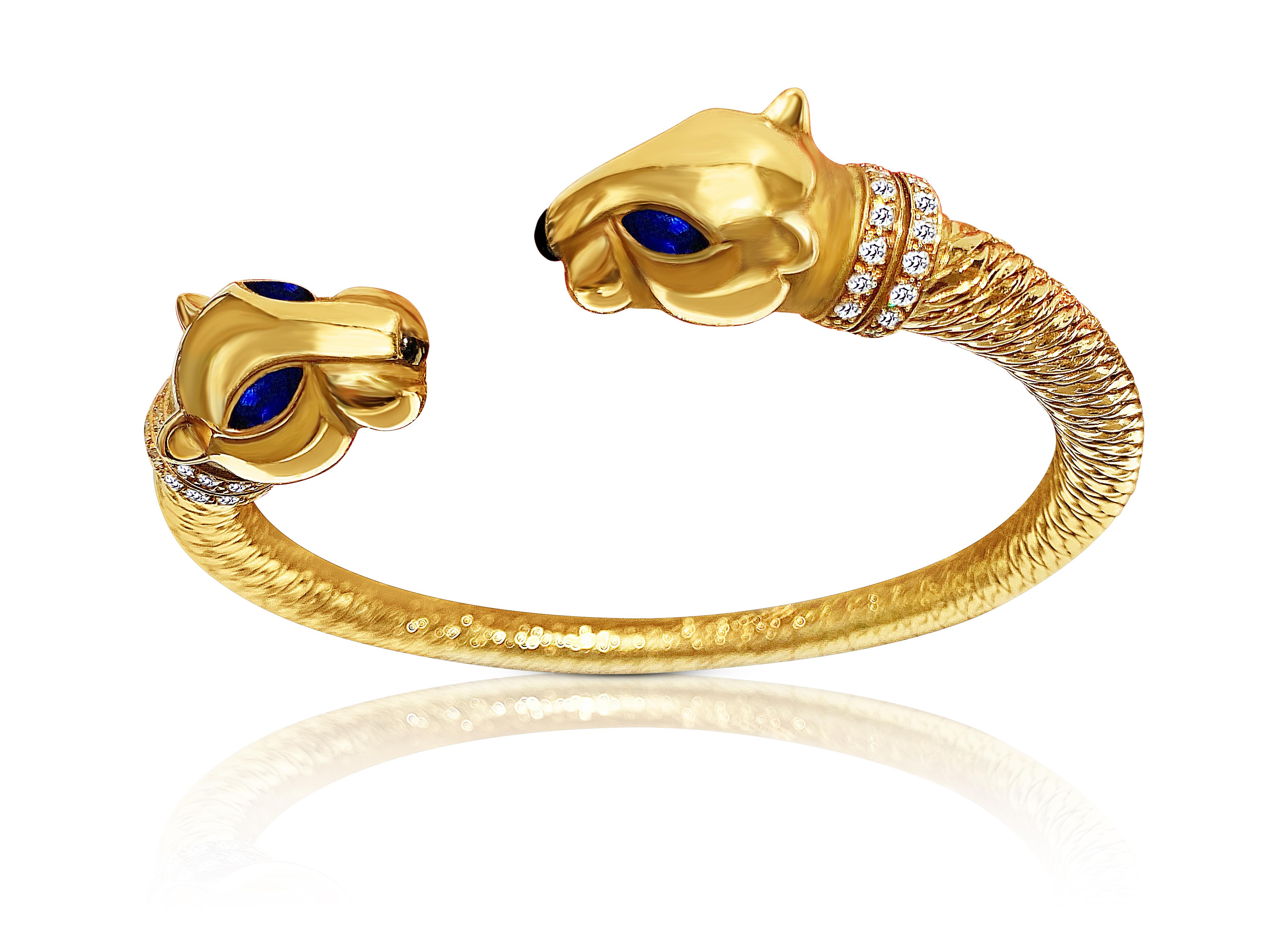 Designed as pair of opposing panthers, set in 18K Yellow Gold and accented by round-brilliant cut diamonds, with Cabochon-Cut Onyx noses, and completed by Marquis-Cut Blue Sapphire eyes. Signed Cartier, numbered #639714, with French assay and