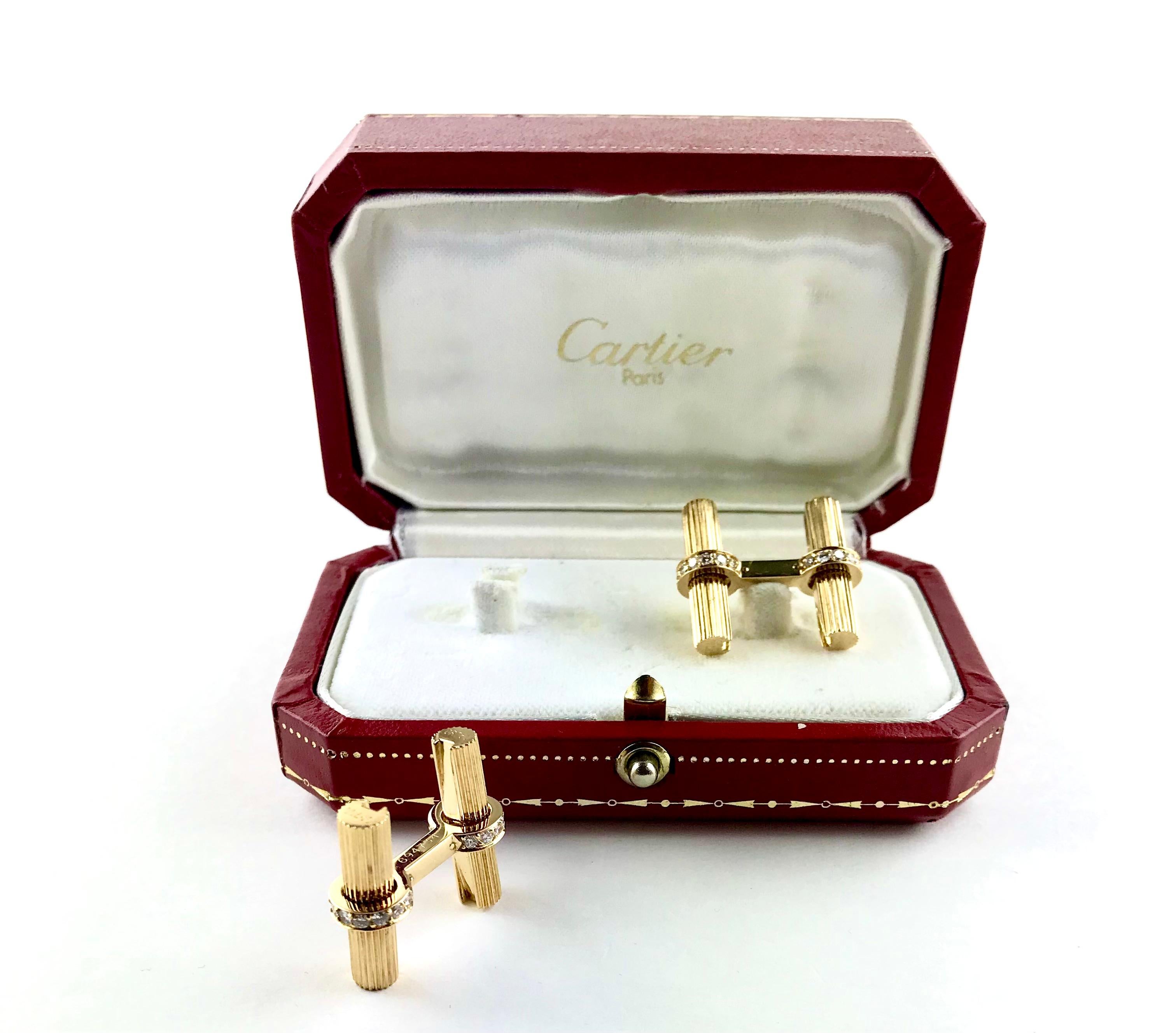 A pair of extremely elegant and recognisable gents 1990’s Cufflinks by Cartier. These exquisite  Cufflinks are composed of two 18k ribbed  Yellow Gold cylinders, baton, encased together by an 18k Yellow Gold bar enlighted by round brilliant-cut