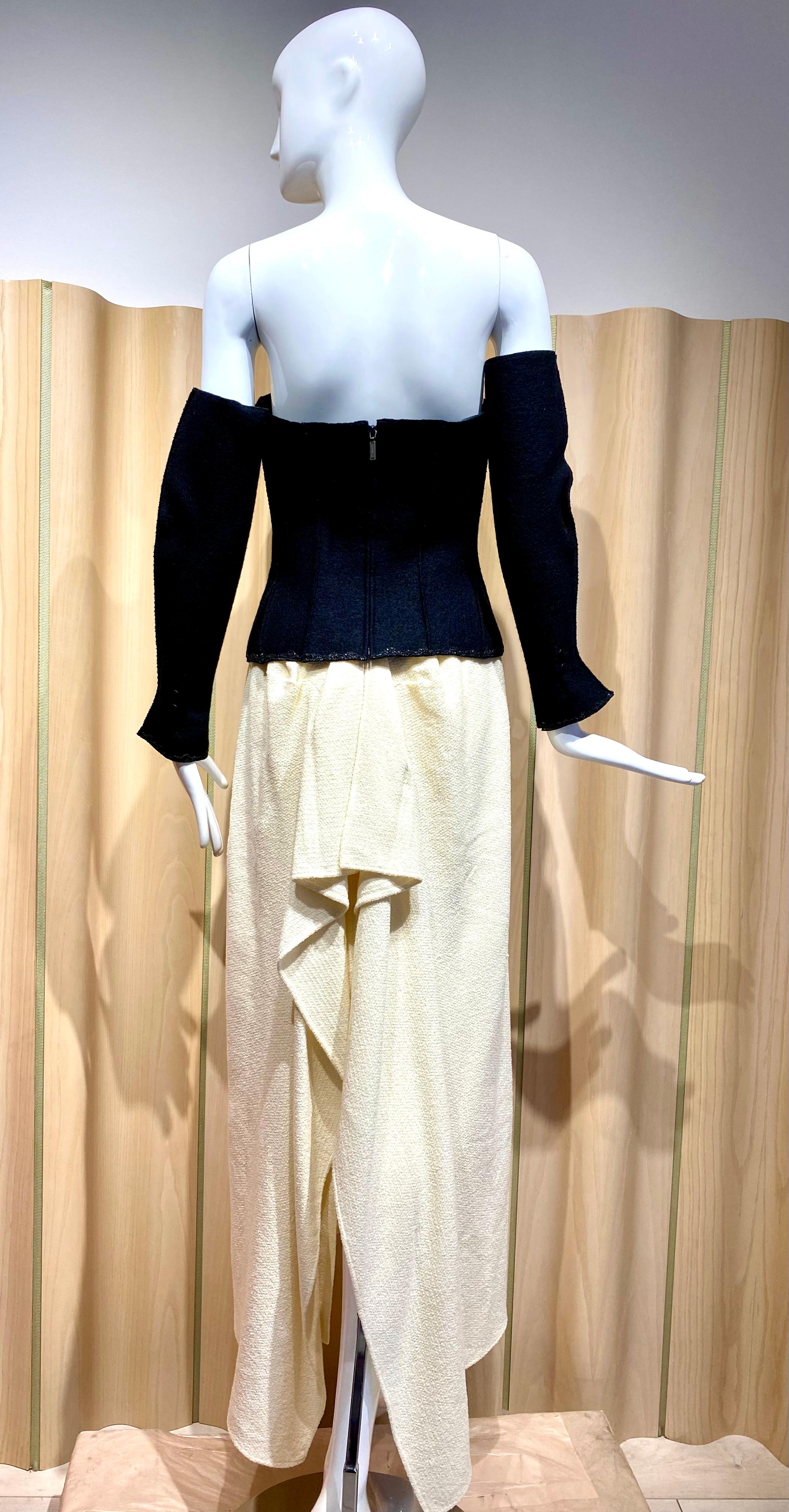 1998 3 pcs Chanel by Karl Lagerfeld Black Crepe Bustier Corset and Creme bustle skirt with detachable sleeves and short sash that you can style it as a strap or scarf.
Perfect for Wedding gown or Black tie event.
Bustier Measurement:  fit 35” Bust /