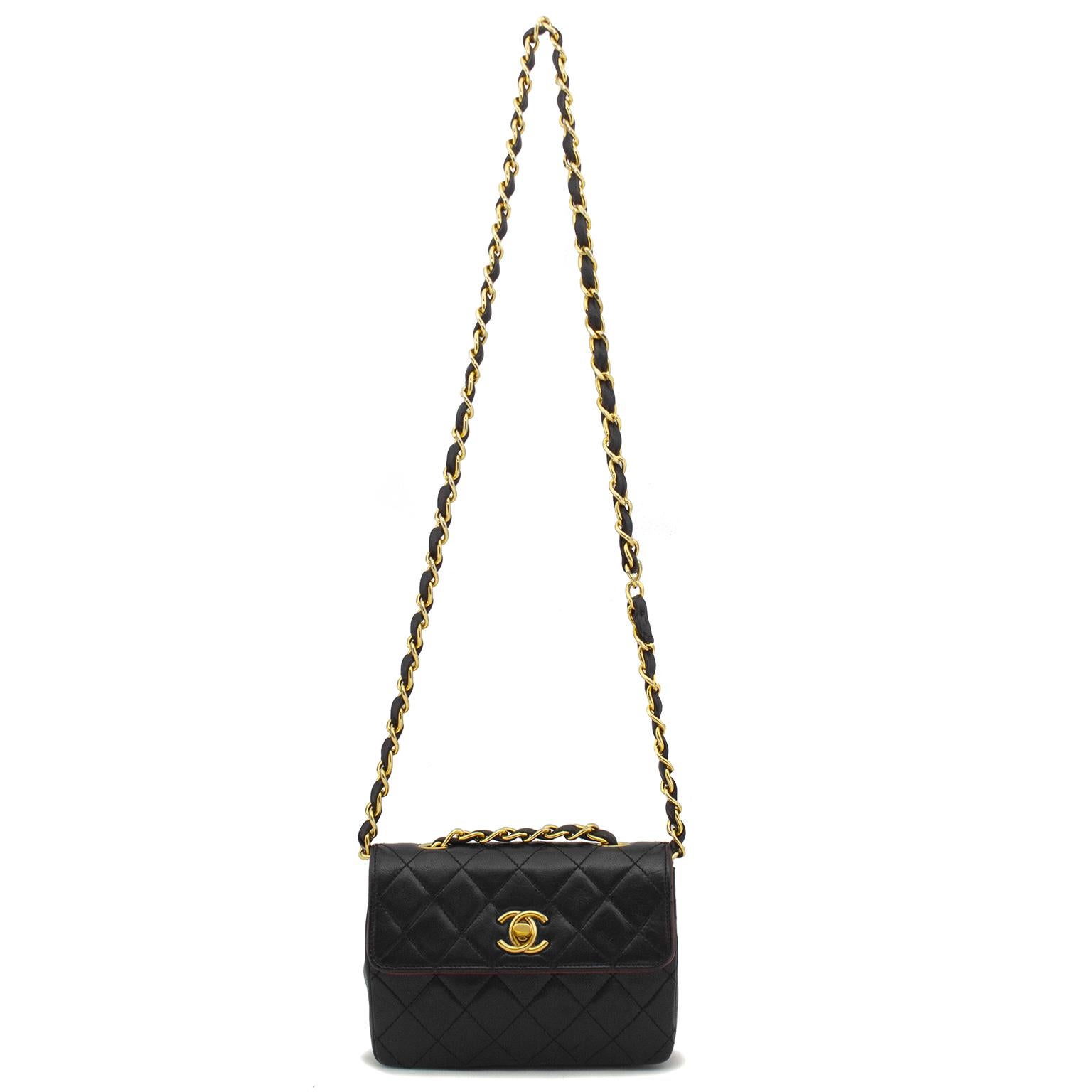 1990s black quilted leather vintage Chanel classic mini flap bag with gold-tone hardware, single chain-link and leather shoulder strap, CC gold-tone turn-lock closure at front flap. Includes dust bag and authenticity card. Excellent vintage