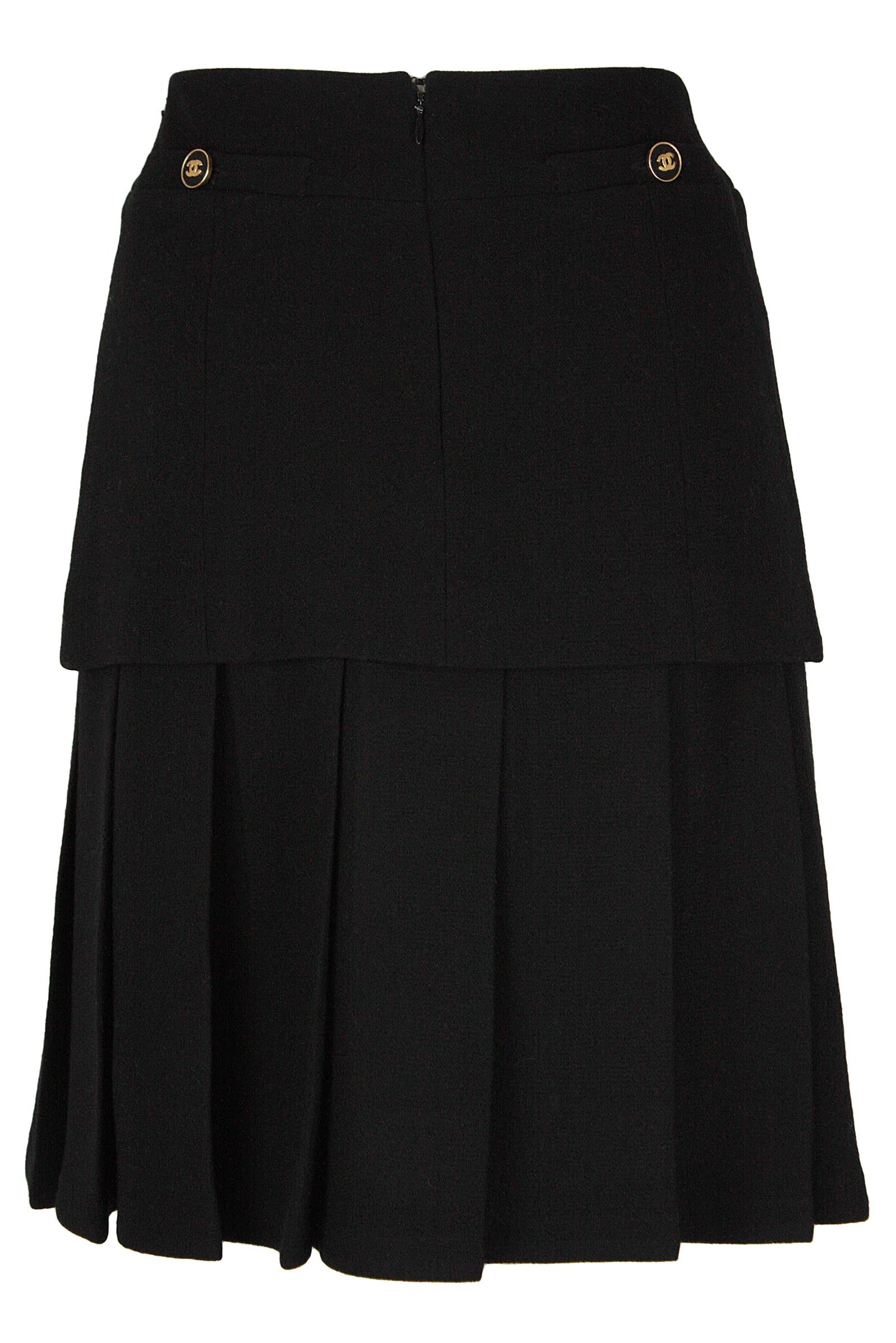 Chanel skirt 
Black wool crepe 
Pleats and panel design 
Back zipper and hook and eye closure 
Gold CC buttons on back faux pockets 
Made in France 
