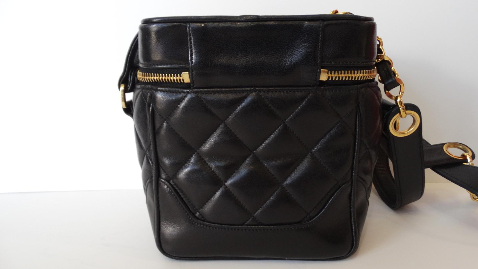 Rock a piece of fashion history with our adorable Karl Lagerfeld Era 1990s Chanel box bag! Made of a soft black lambskin leather stitched with Chanel's signature quilting. Iconic gold and black chain strap woven with leather to match. Oversized 