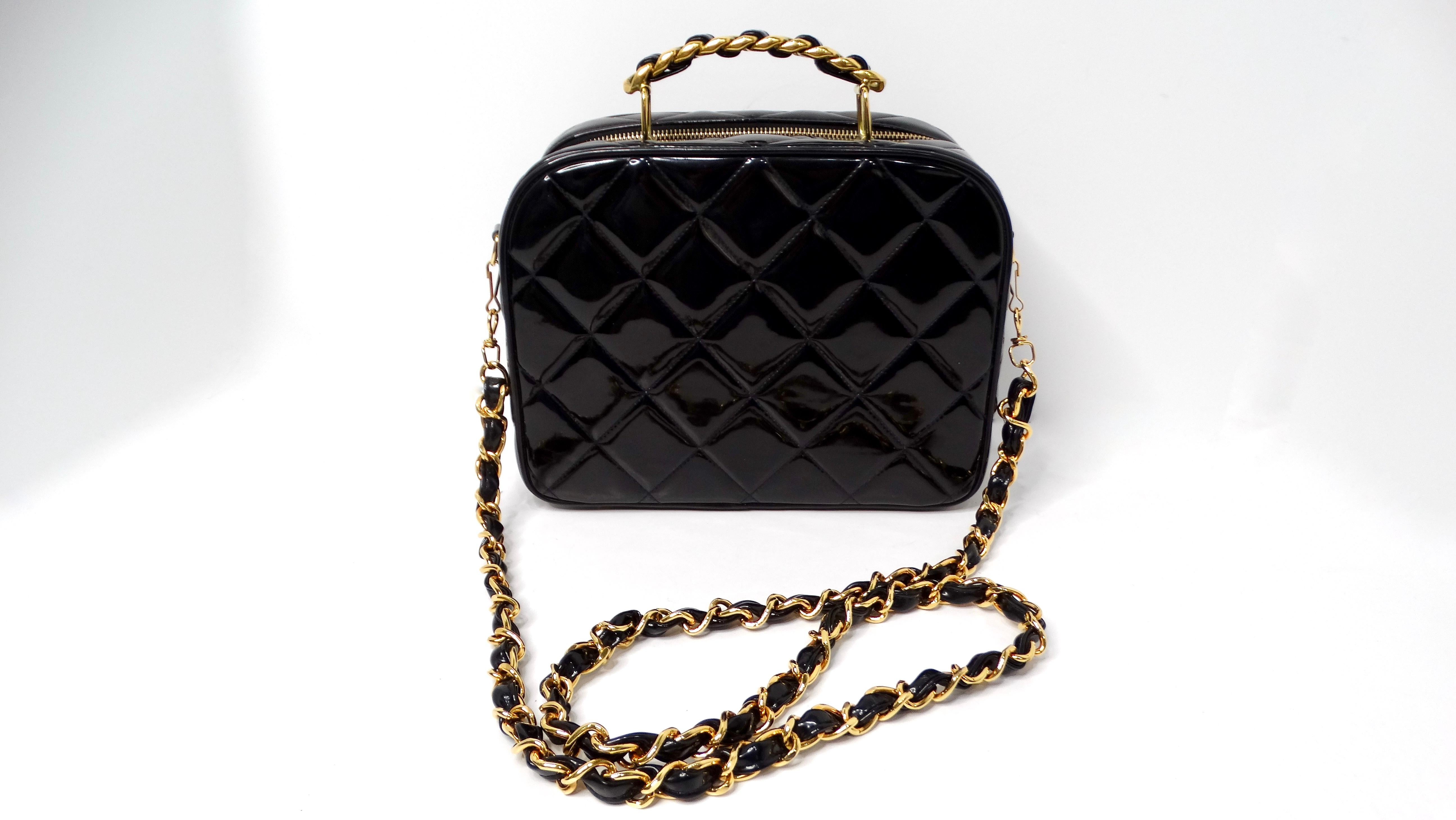 Introducing the stunning 1990s Chanel Black Quilted Patent Leather Zip-Around Box Top Handle Bag, a true statement piece that embodies sophistication and luxury. Crafted from high-quality patent leather, this bag features the iconic quilted design