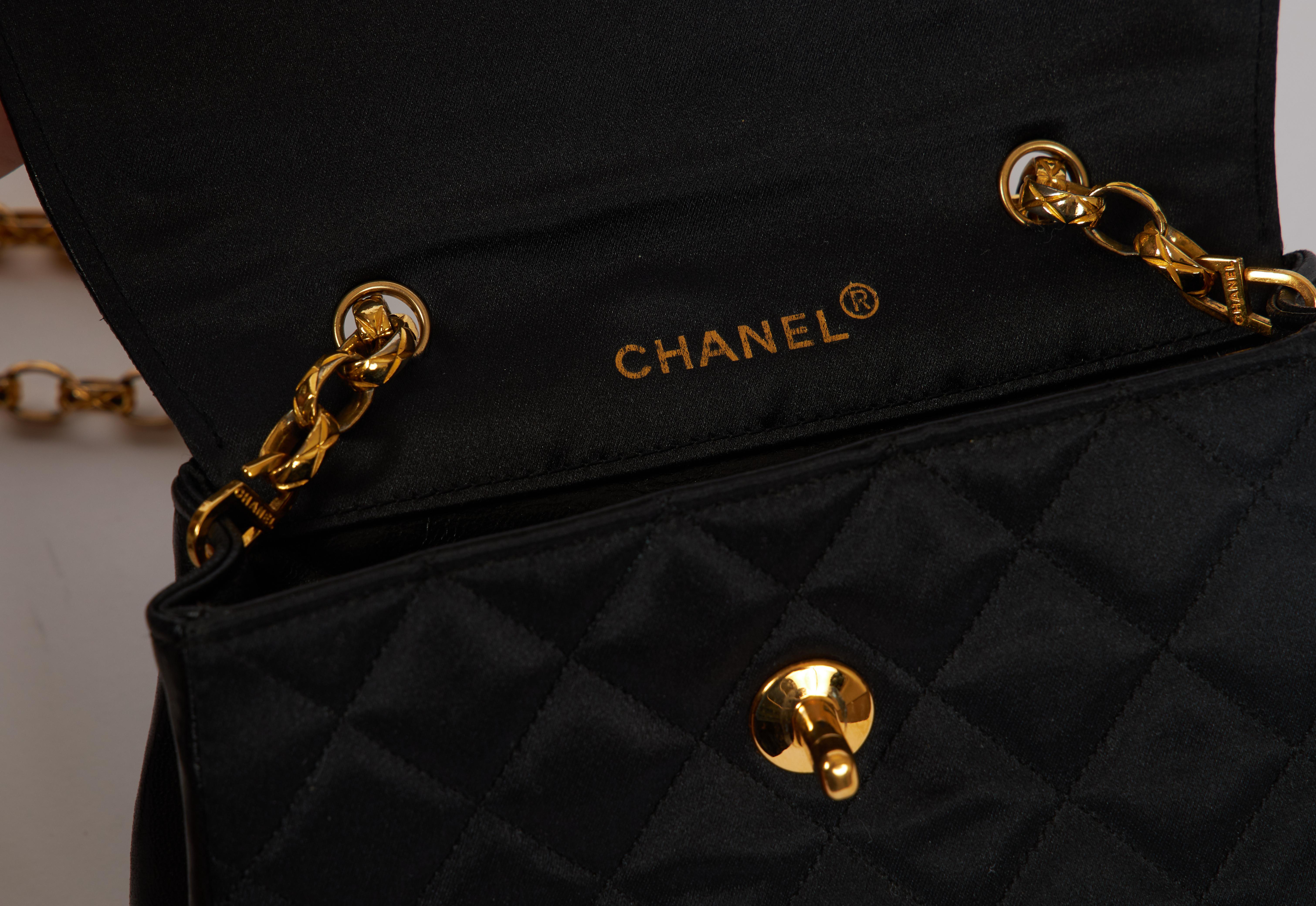 1990s Chanel evening bag with matching detachable wallet. Black satin silk with leather trimming and goldtone metal hardware. Shoulder drop, 20.5