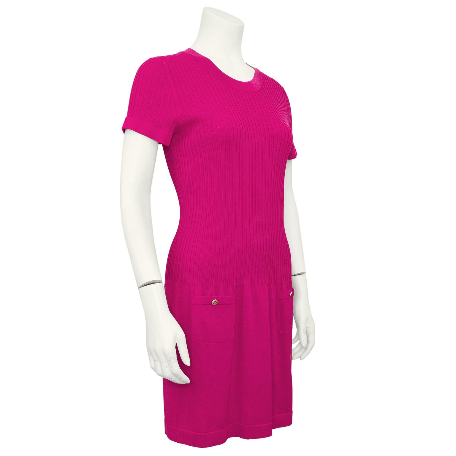 Chanel resort 2011 dark magenta short sleeve dress. Crew neckline with ribbed sleeves and bodice. Body con to the drop waist with a very slightly flared short skirt. Pockets at hips with gold tone interlocking cc logo buttons. Lightweight 57% cotton