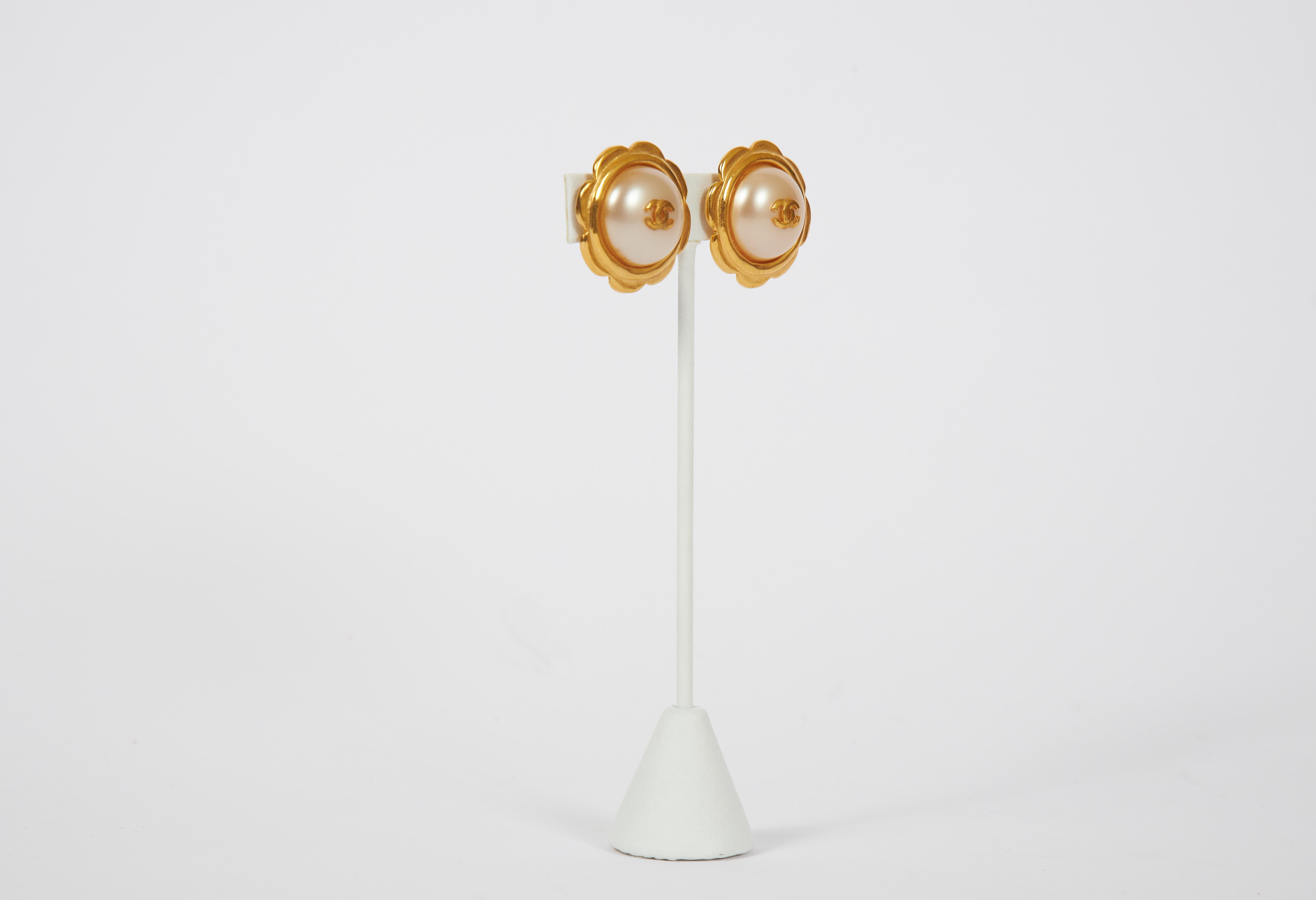 Chanel faux-pearl earrings with goldtone metal flower-form settings. Clip backs. Spring '97. Original box included.