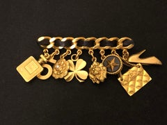 Vintage CHANEL Gold Toned Leather Chain Perfume Lion Camellia Clover Brooch