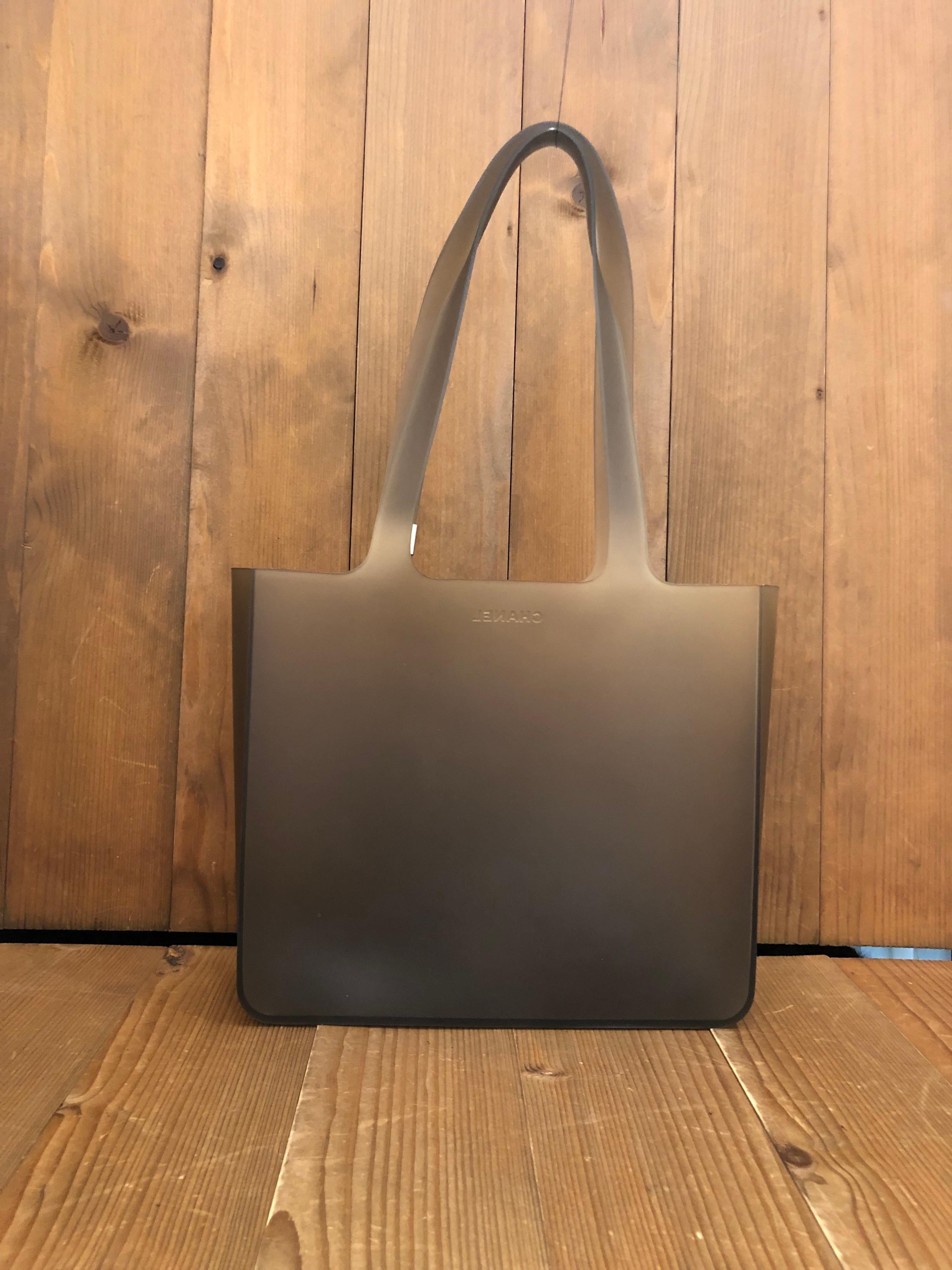 1990s Chanel tote bag in gray translucent silicone. Measures 9.5 x 8.5 x 3 inches Handle Drop 9.5 inches. 

Condition - Some signs of wear consistent with age and normal use 

