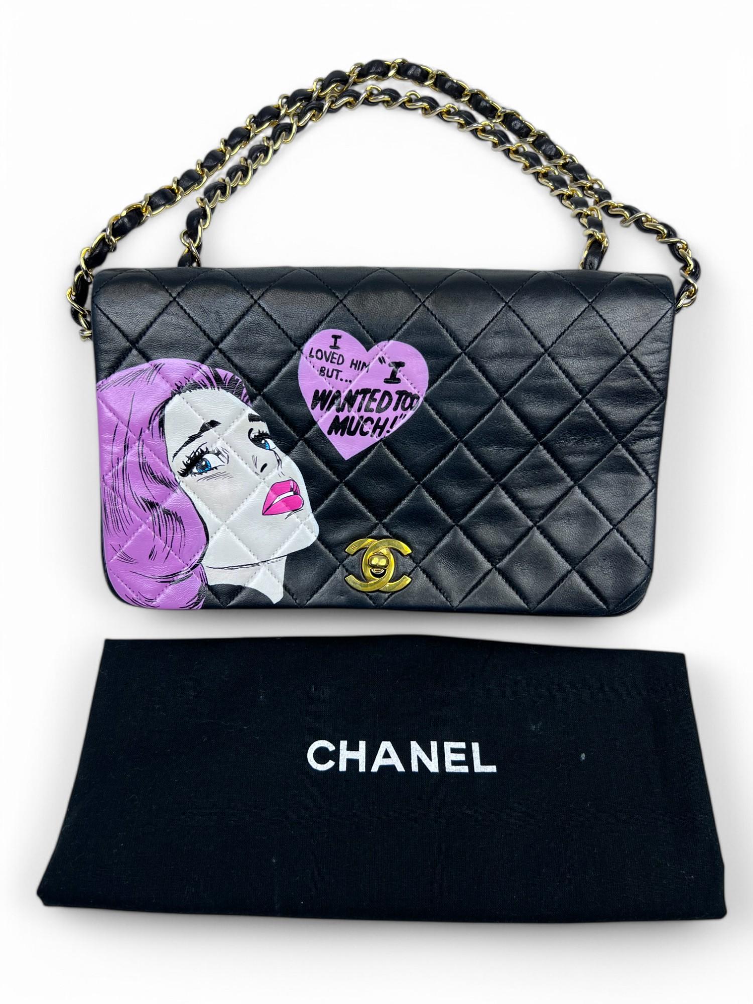 This rare 1990s Chanel crossbody bag has been transformed into a one-of-a-kind wearable artwork by a contemporary Pop artist. The bag features a bold, expressive hand-painted design with the phrase 