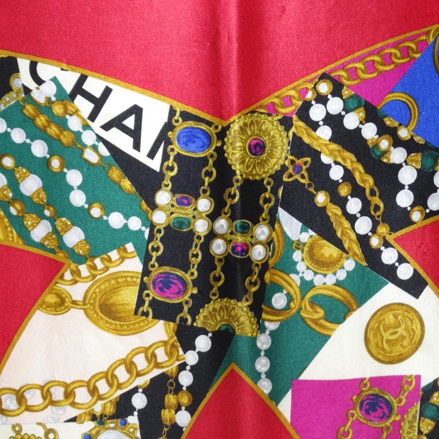 Gorgeous vintage Chanel 100% silk scarf circa 1990s! Featuring a large signature Chanel interlocking 'C' logo in a jewel print graphic complimented by the most stunning and vibrant ruby red and a small Chanel logo in the lower corner. This is such a