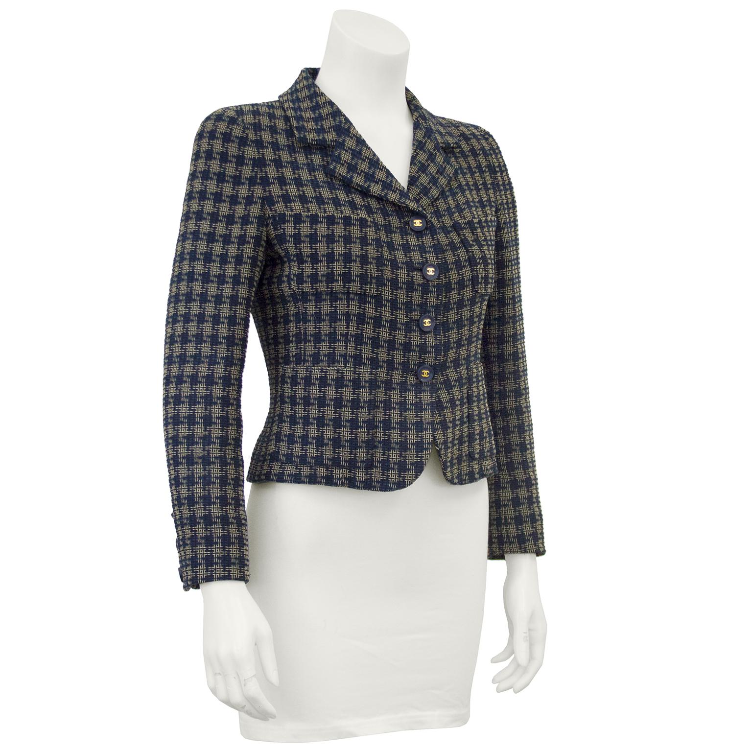 Chanel navy and cream woven plaid cropped jacket with a notched lapel, four front patch pockets and 4 buttons up the front. In excellent condition, with matching navy CC buttons on the cuffs. Fits like a US 0-2. 