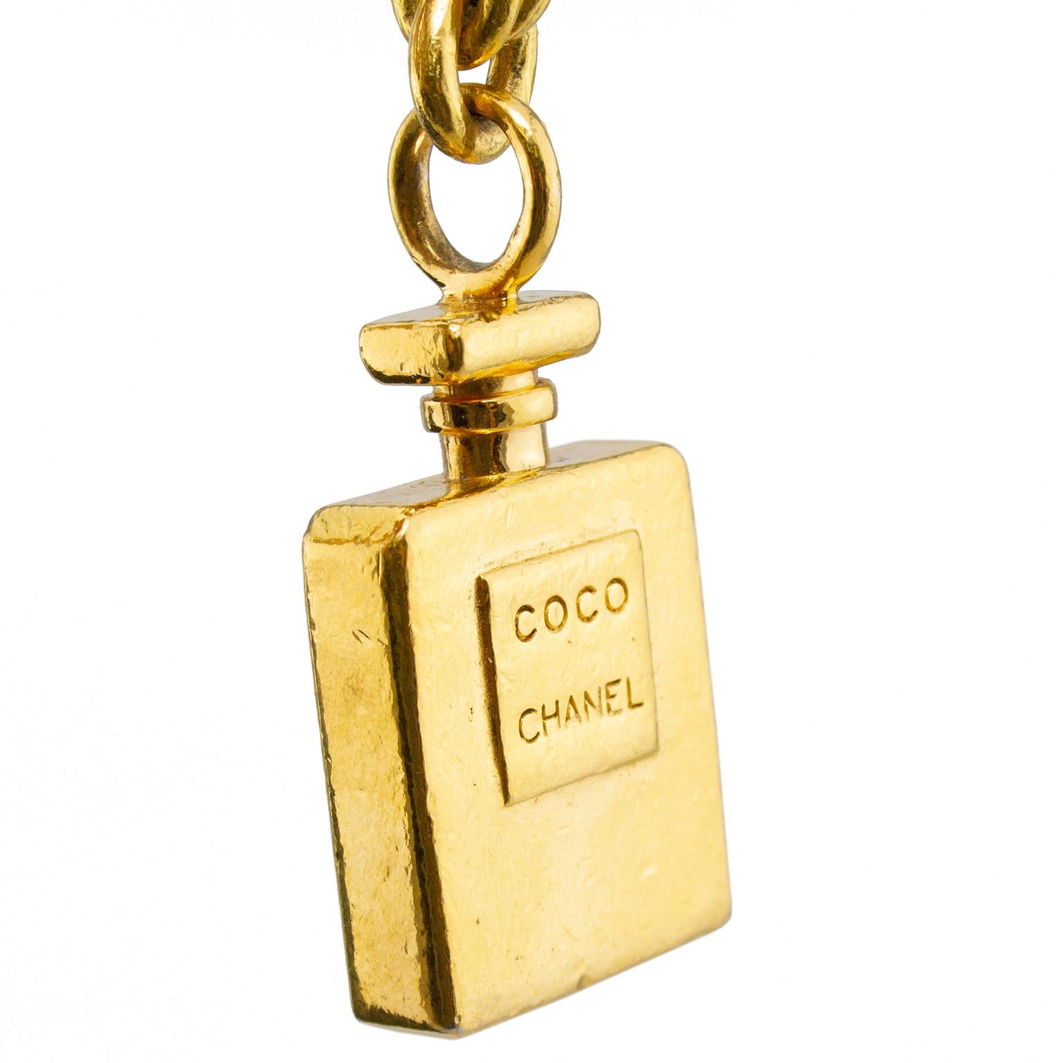 1990s Chanel thick gold tone chain link necklace with pendant of the iconic Chanel No 5 perfume bottle. The distressed finish on the bottle is part of the design, not from overuse or damage. Lobster clasp closure. Excellent vintage condition. Made
