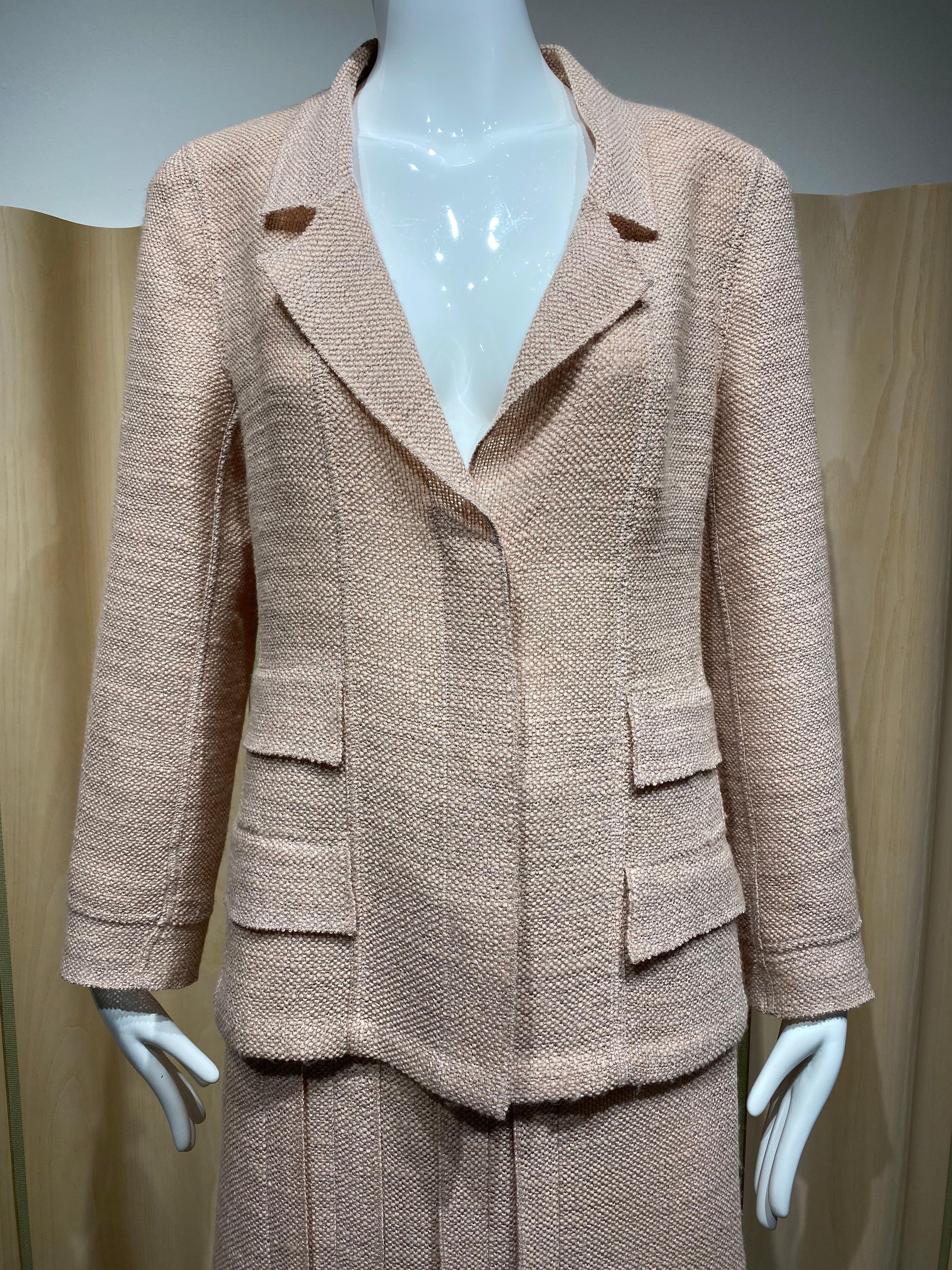 Vintage 90s Chanel blush pink /pale pink light wool suits lined in silk.
Blazer has clear acrylic button. Skirt is knee length.
Marked size: 42fr / Medium - Large 
Measurement for Blazer/ Jacket: 
BustL 39” / Waist: 36”/ Hip: 42” / Sleeve length: