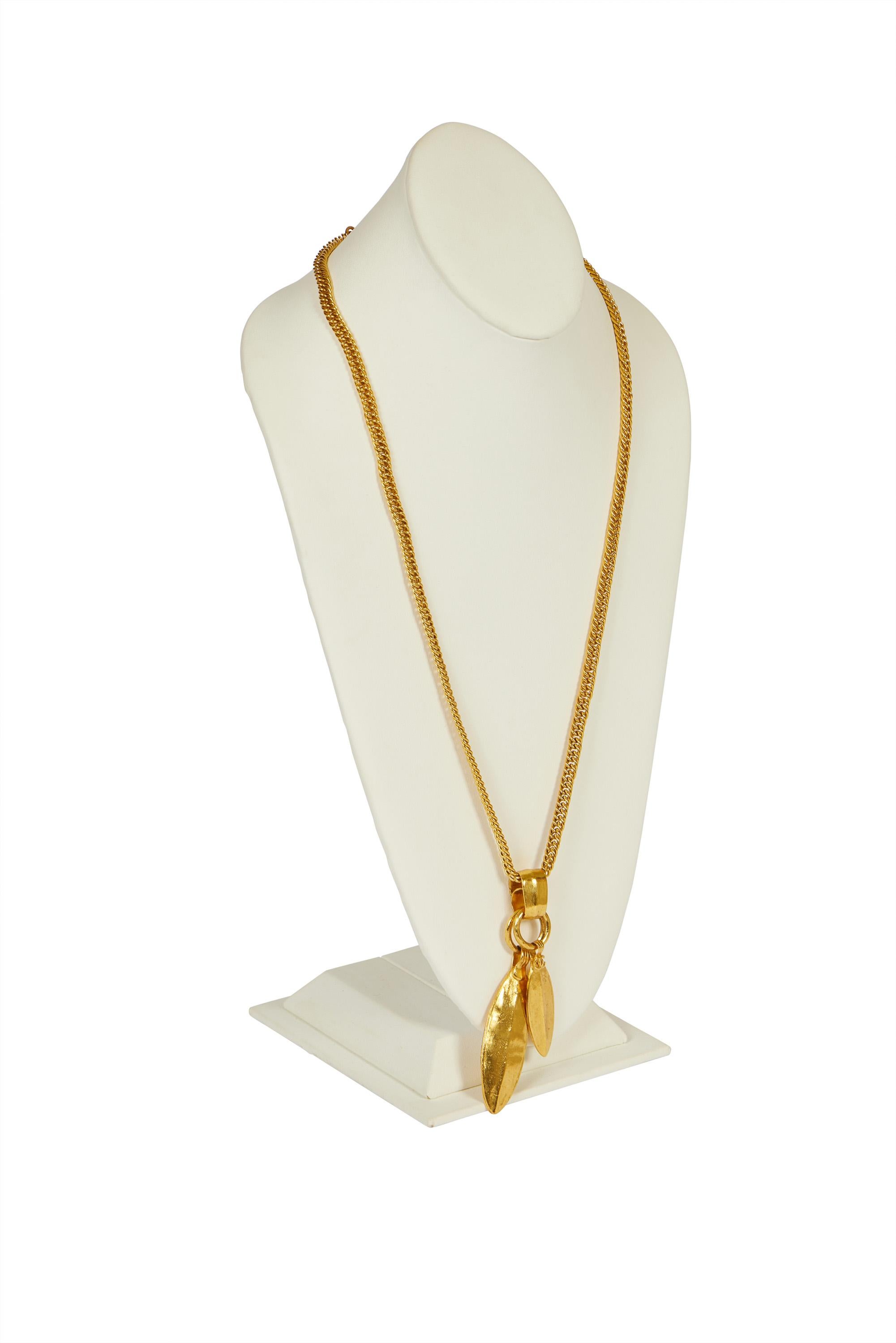 Chanel satin gold long necklace with double leaf pendants. Collection spring 98. Comes with original pouch or box.

