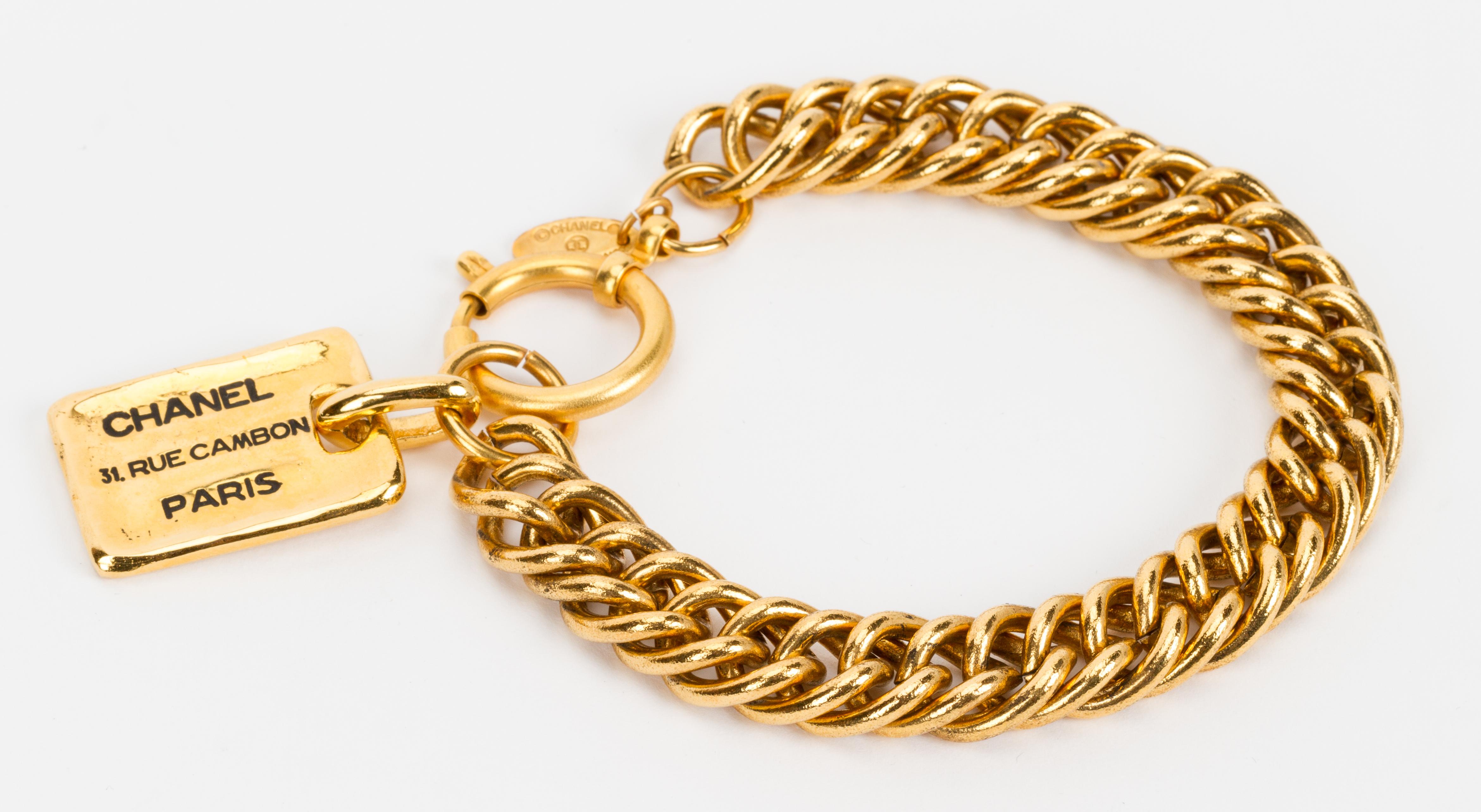Chanel 80s extra long gold plated link bracelet with dog tag charm. Excellent condition. Comes with original box.