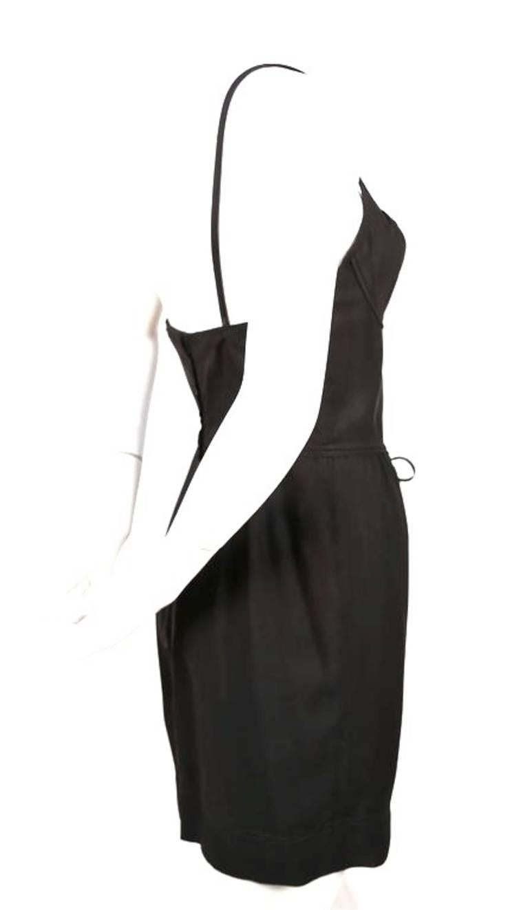Jet black bustier mini dress from MOSCHINO CHEAP & CHIC dating to the 1990's. Narrow adjustable straps and bow at waistline. Labeled an Italian 42 however this dress best Fits an Italian size 40 or US 2/4. Approximate measurements: armpit to armpit