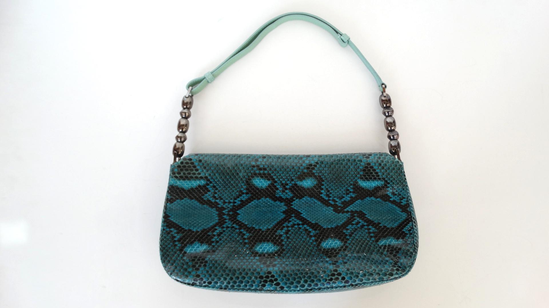 Add Some Color To Your Outfit With This Dior Bag! Circa 1990s, this adorable bag features blue snakeskin, a light blue adjustable single top handle and gunmetal hardware. On the front face 