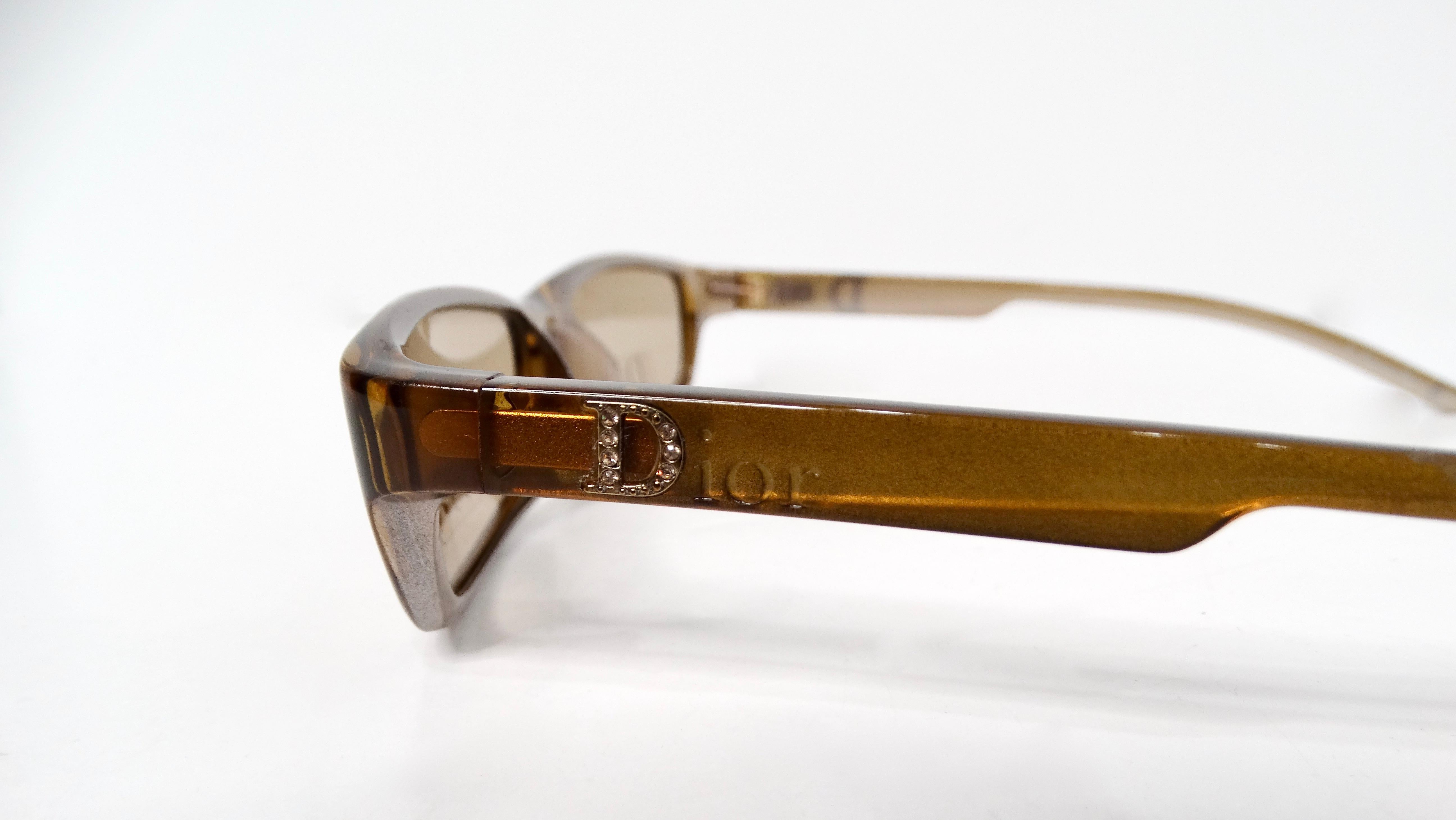 Step into the timeless elegance of the 1990s with these exquisite Christian Dior brown rectangular sunglasses, a statement piece that perfectly blends vintage charm with contemporary flair. The translucent amber brown hue adds warmth and