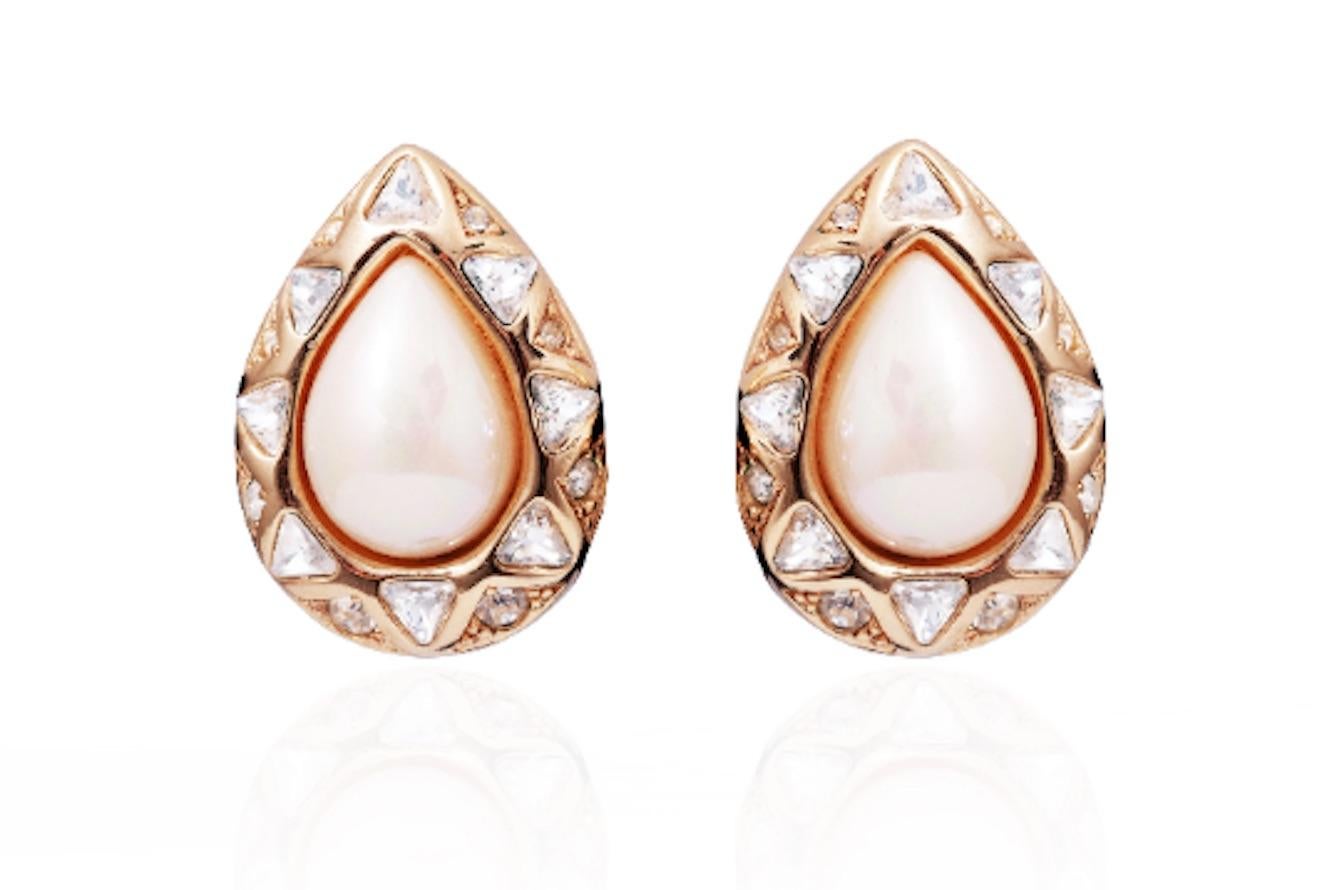 Vintage 1980s or 1990s Christian Dior gold-plated clip-on earrings set with a lustrous iridescent teardrop shaped pearl as the centre price.  The pearl is then surrounded with both trillion cut and smaller brilliant cut crystal diamantes.  The
