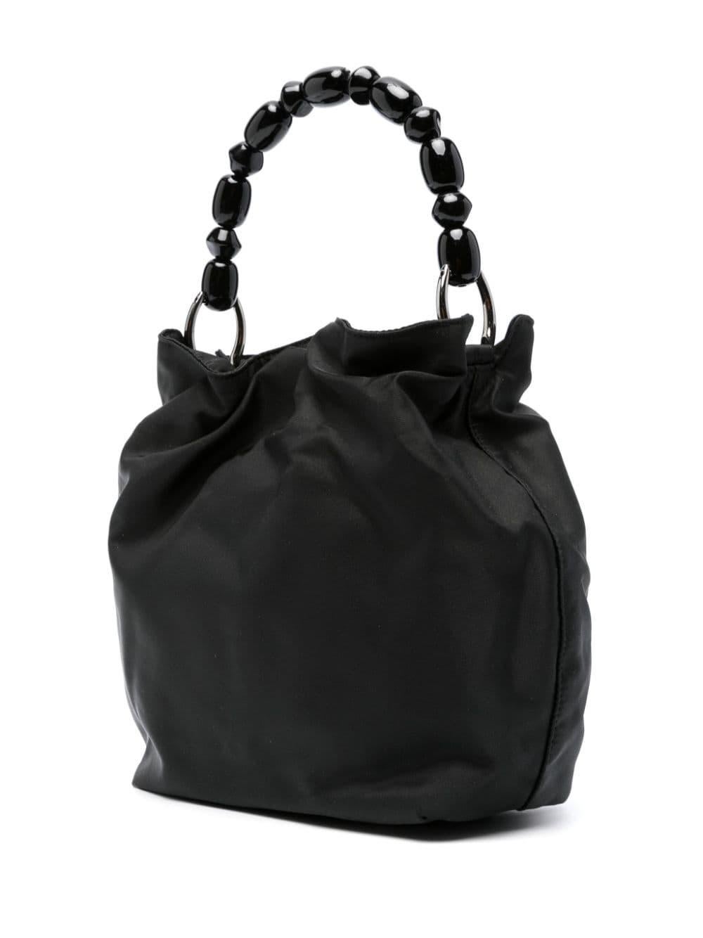 1990s Christian Dior black nylon Malice tote bag featuring a shiny nylon finishing, black shiny beads handle, a front signature 