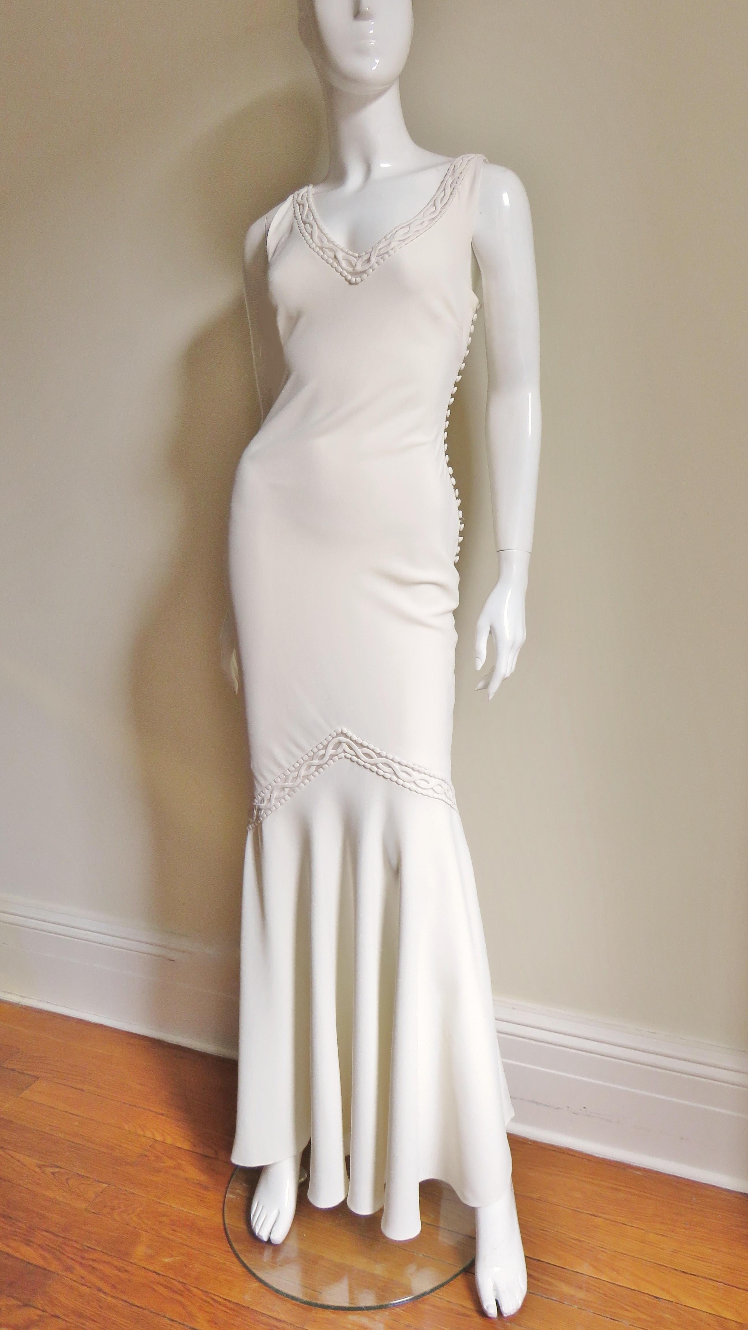 A stunning off white silk gown from Christian Dior.  It has a plunging neckline front and back bordered with an 1 1/2