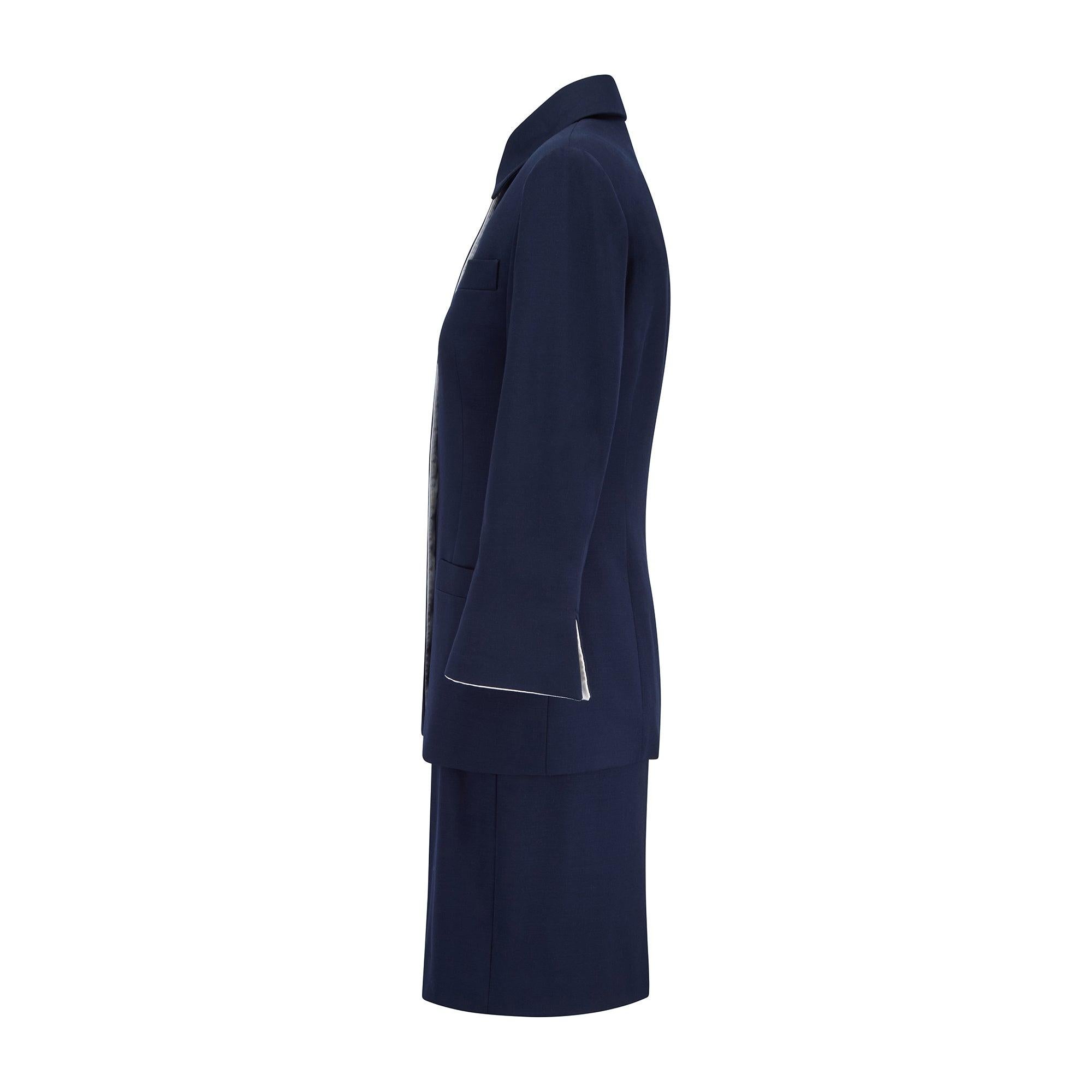 This early 1990s Christian Dior navy and white polka-dot three piece suit is comprised of a skirt, jacket and sleeveless top.  The ensemble would have been designed by Gianfranco Ferre during his eight year tenure as Creative Director of the House.
