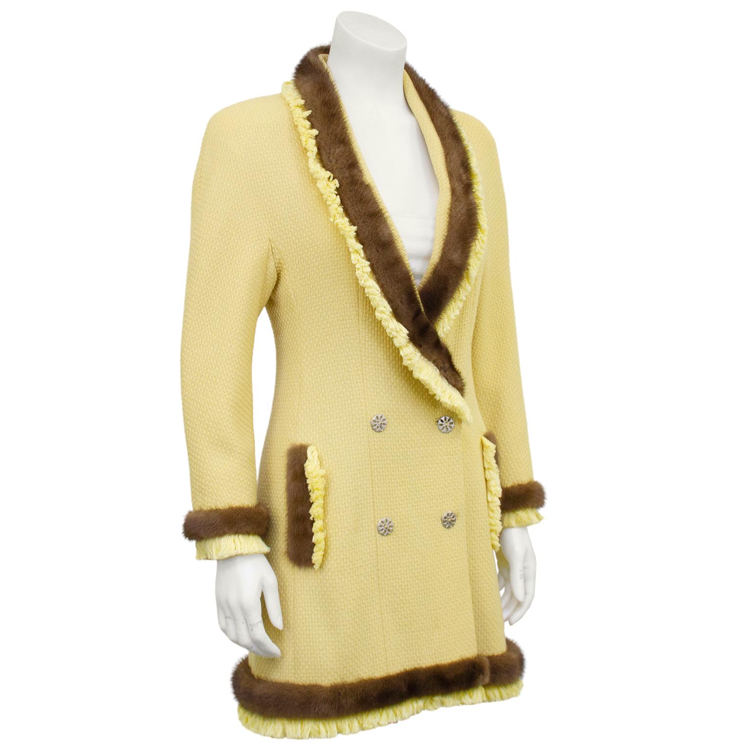 The most amazing 1990's Christian Dior Boutique long jacket. Pale yellow bouclé trimmed in rich contrasting brown mink and matching yellow fringe. Deep shawl collar and double breasted silver metal floral buttons. Yellow satin lining. Excellent