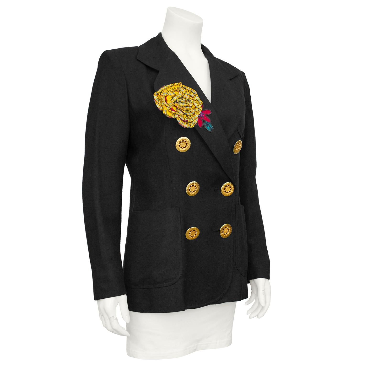 1990s Christian Lacroix double breasted linen blazer. Features large gold tone metal buttons, oversized notched collar and large patch pockets. Yellow and red appliqué flower on right side of bust. Black and white vertical stripe lining. Excellent