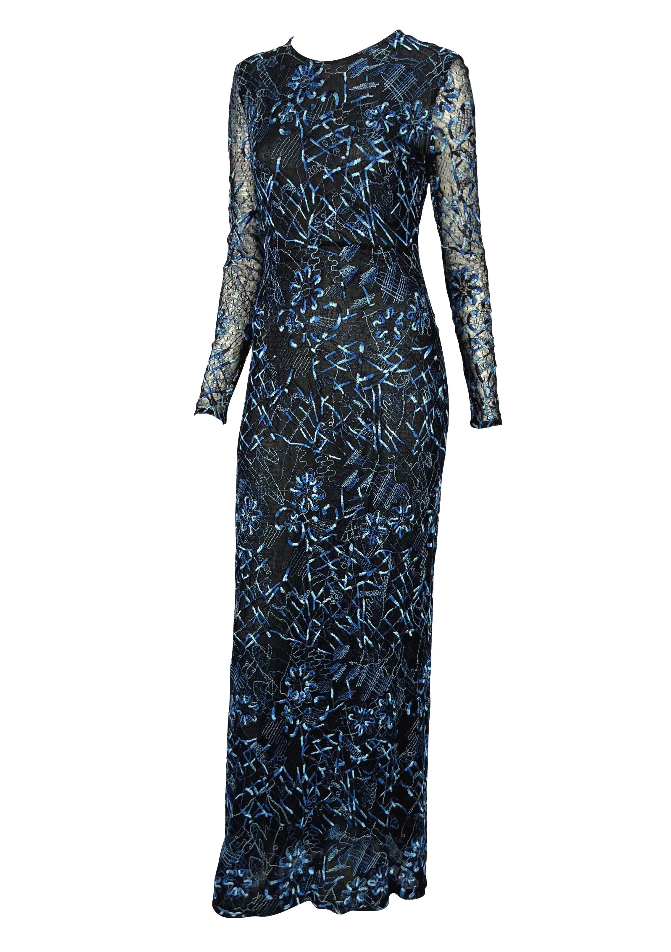 Presenting an incredible blue and black Christain Lacroix gown. From the Spring/Summer 1998 collection, this fabulous dress is constructed of black mesh lace and features an abstract floral embroidered pattern throughout. The column dress is made