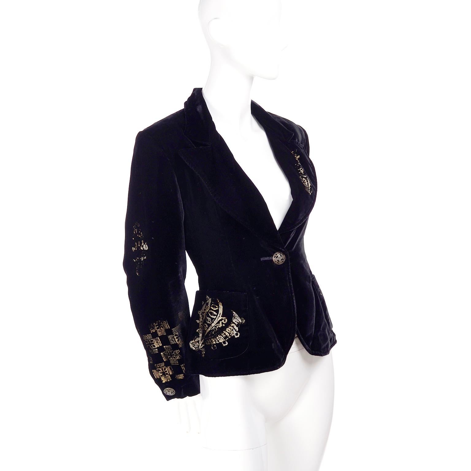 This is a lovely 1990's vintage black velvet blazer from Christian Lacroix with a stamped gold design. We love Christian Lacroix and have had many of his pieces over the years! This jacket closes with a front decorative pierced metal button, is