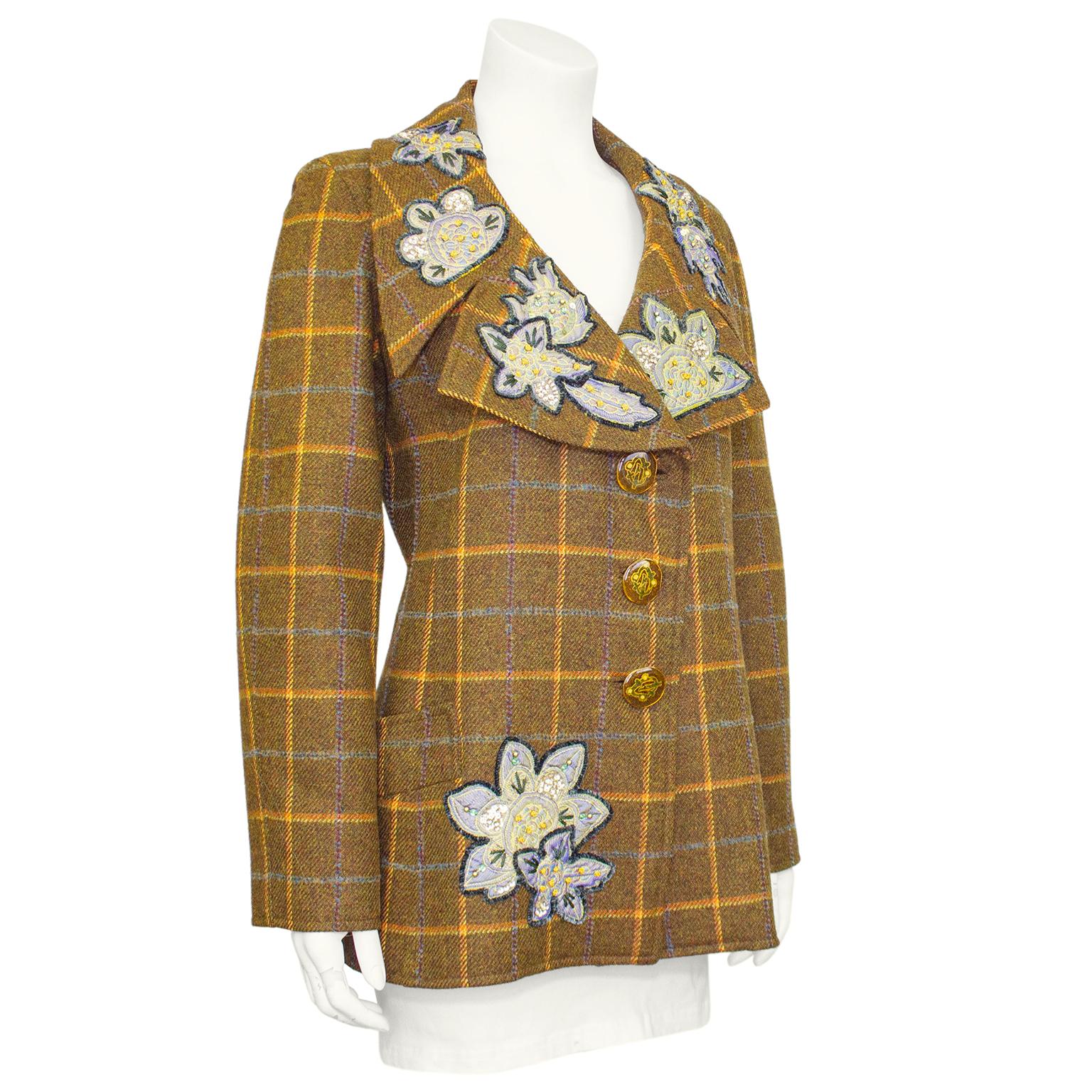 Christian Lacroix jacket from the 1990s. Brown, orange yellow, blue and purple wool plaid. Oversized, notched shawl collar, three large monogrammed plastic buttons and horizontal slit pocket at hips. Collar and right hips are embellished with large